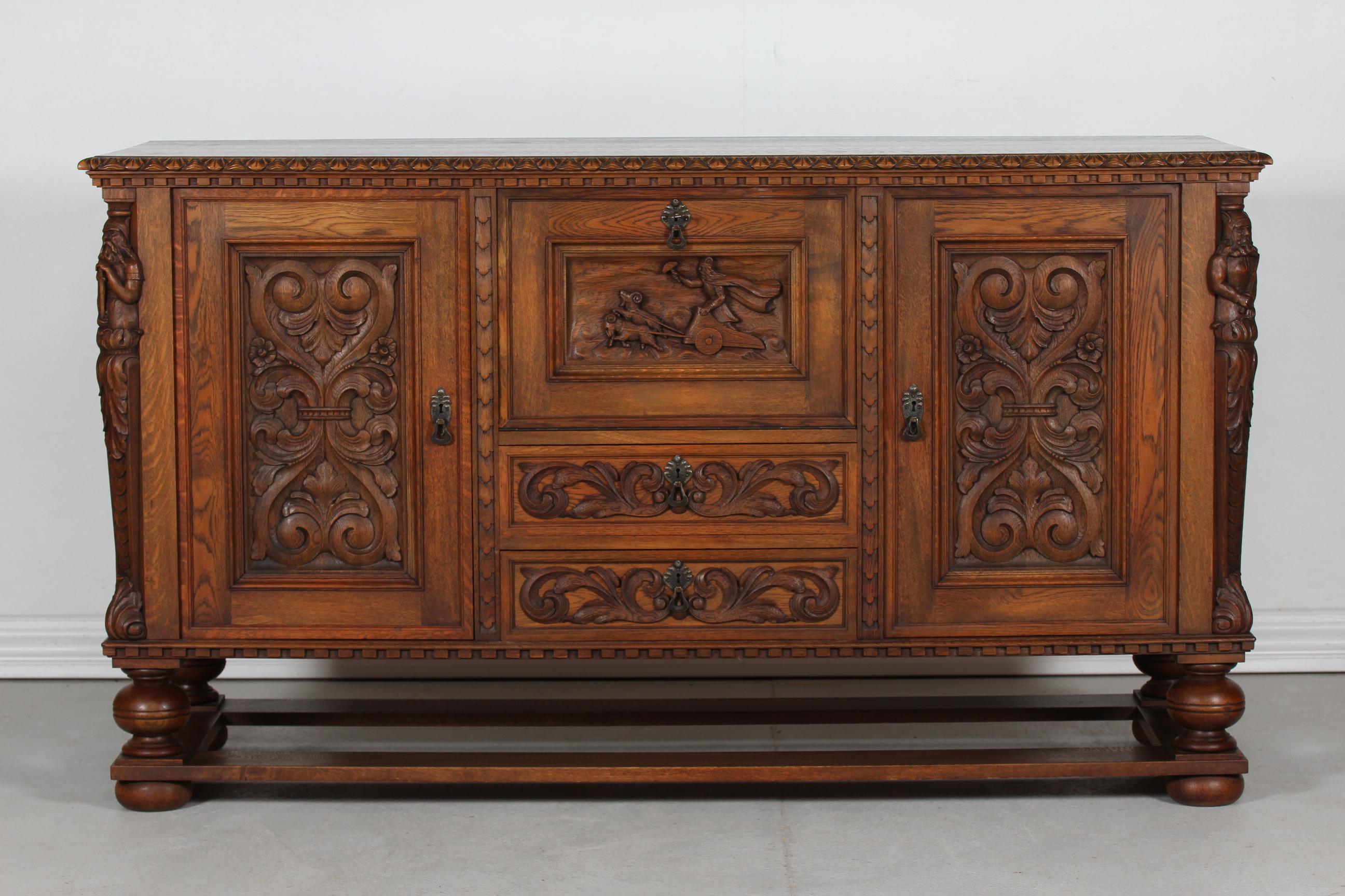 Danish Historicism sideboard in solid oak, made in the early 20th century by a Danish cabinetmaker.
Chunky legs and a sculptural front with hand-carved figures of Odin and Thor from the Danish history of Nordic mythology.

This sideboard would
