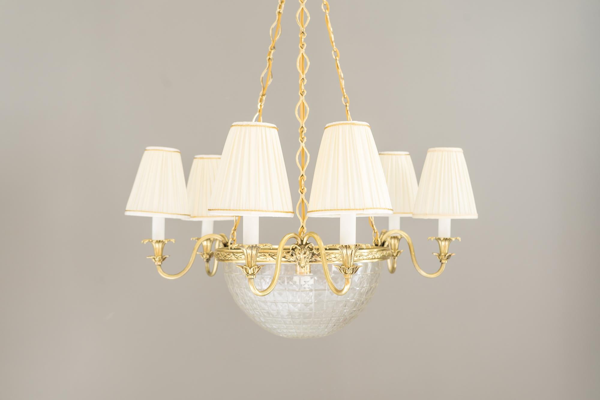 Historistic brass chandelier, Vienna, 1890s
Polished and stove enameled
Cut glass
The fabric shades are replaced (new).