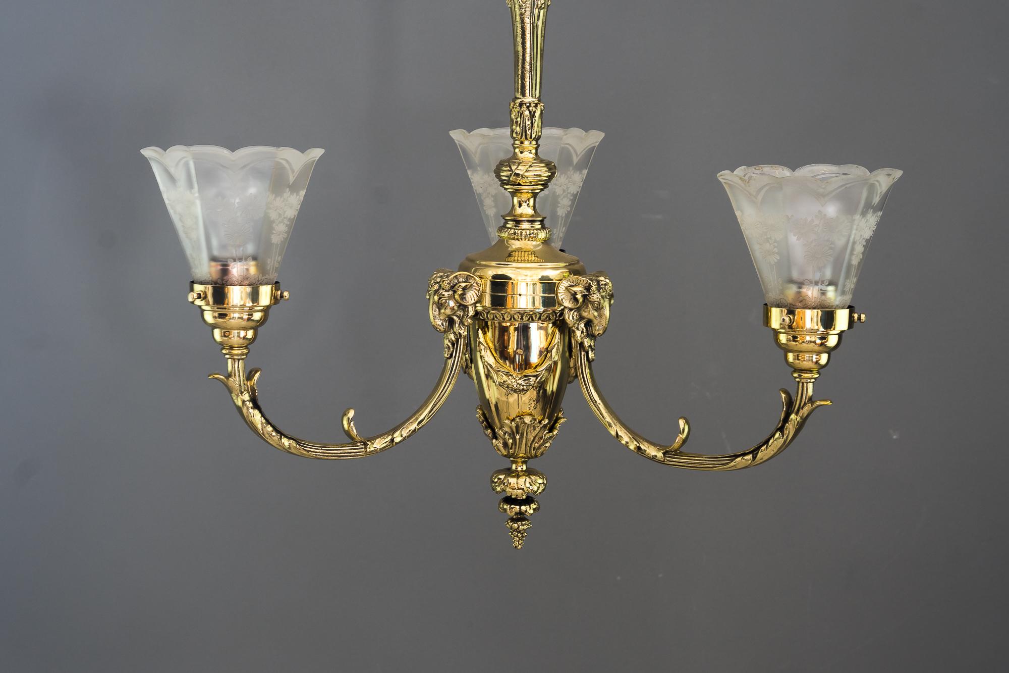Historistic chandelier vienna around 1890s with Capricorn heads
Brass polished and stove enamelled
Original old glass shades.