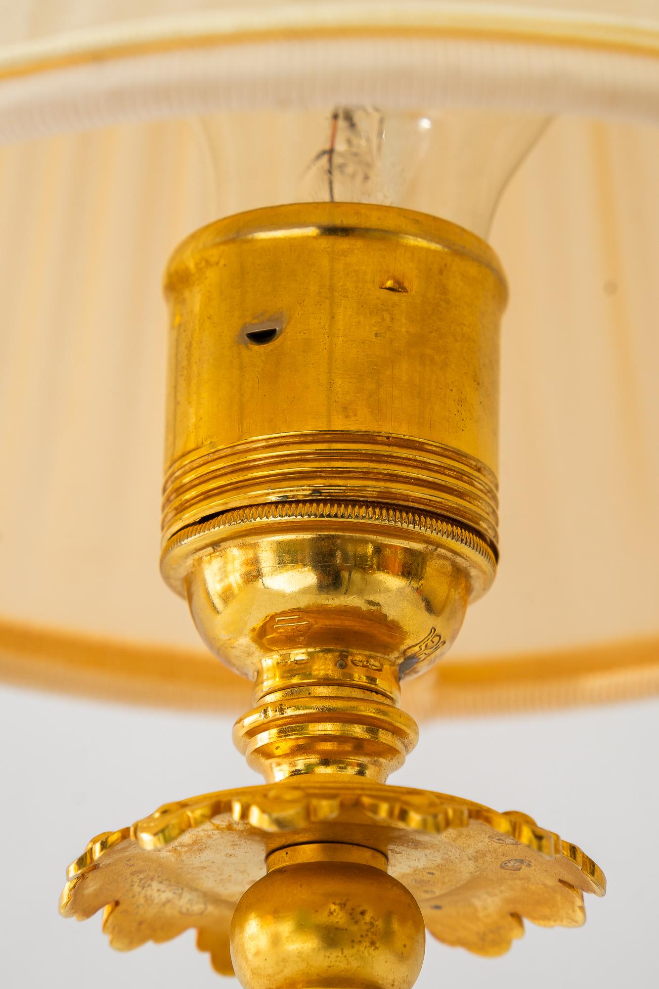 Gilt Historistic fire gilted table lamp with fabric shade vienna around 1890s For Sale