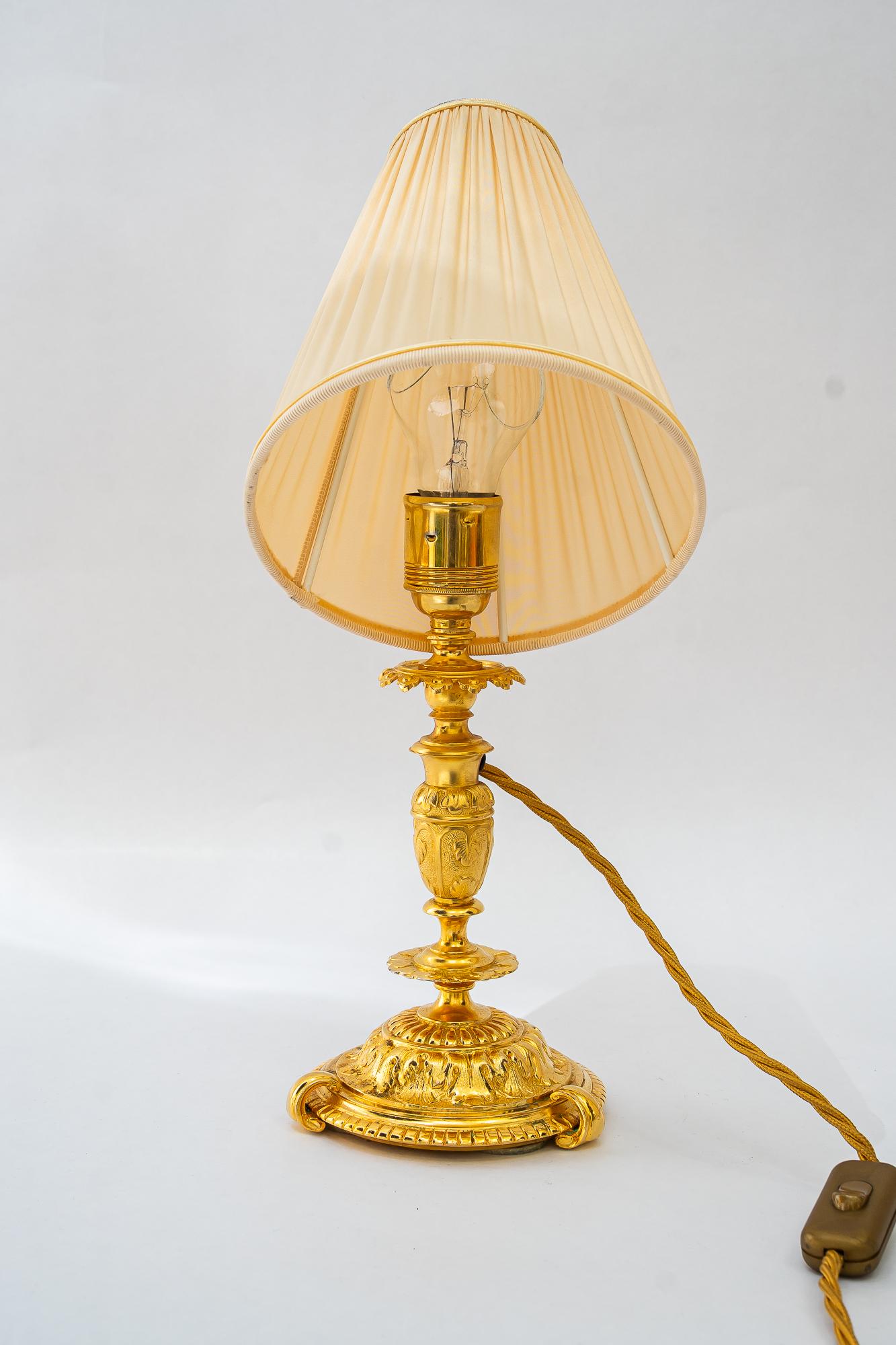 Brass Historistic fire gilted table lamp with fabric shade vienna around 1890s For Sale