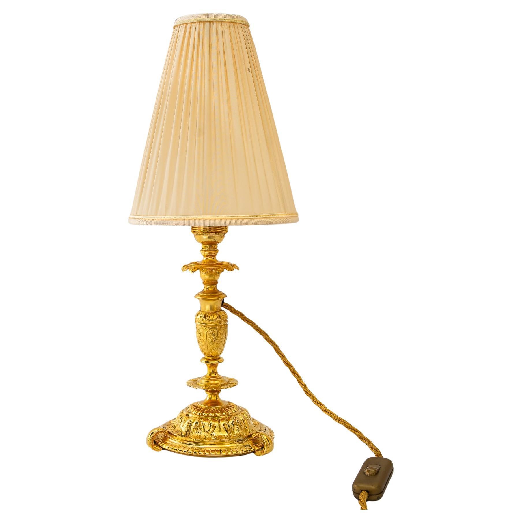 Historistic fire gilted table lamp with fabric shade vienna around 1890s