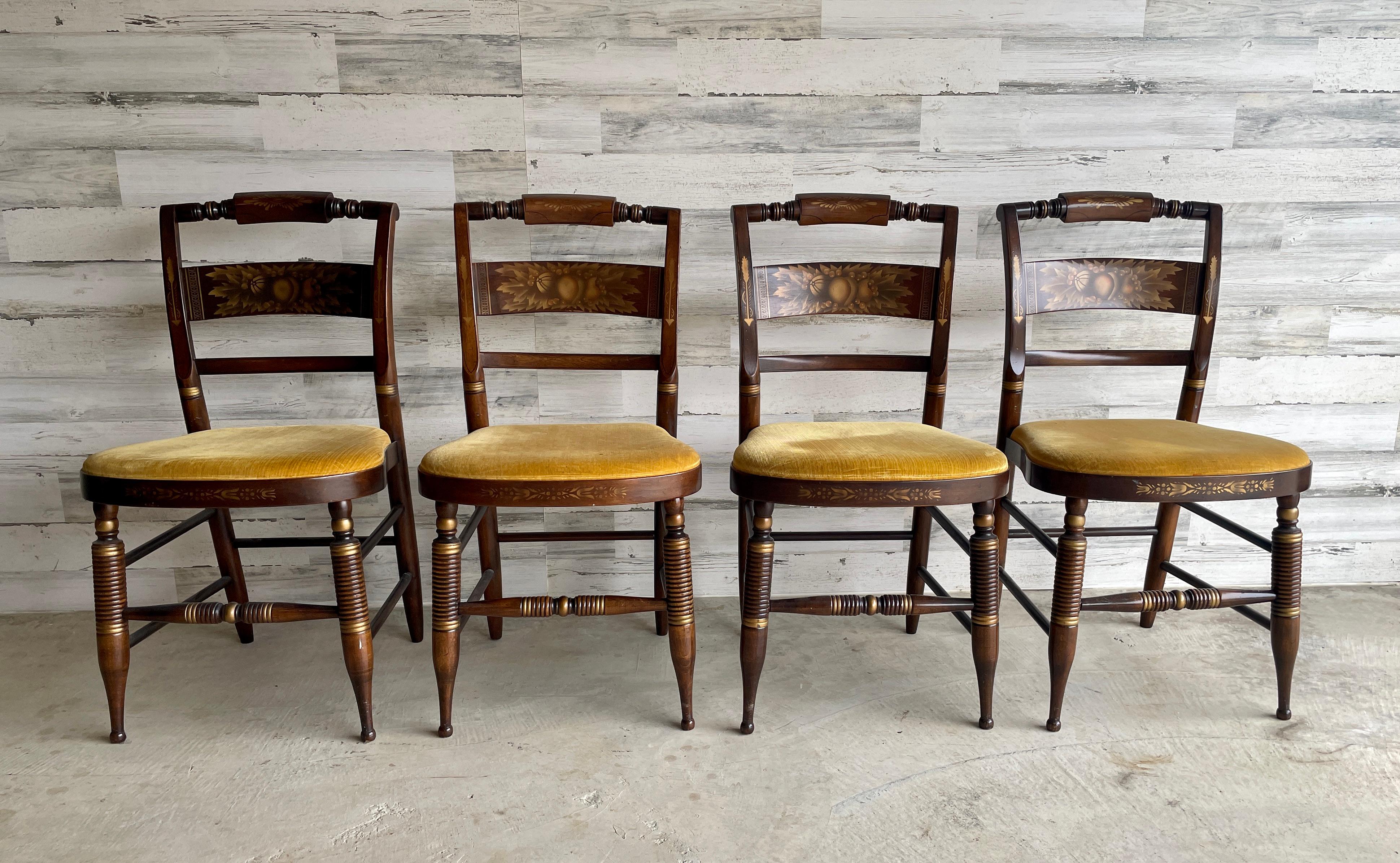 Sillas de comedor Hitchcock - Juego de 4. Patas y armazones de madera torneada con motivos frutales estarcidos en dorado en los respaldos.