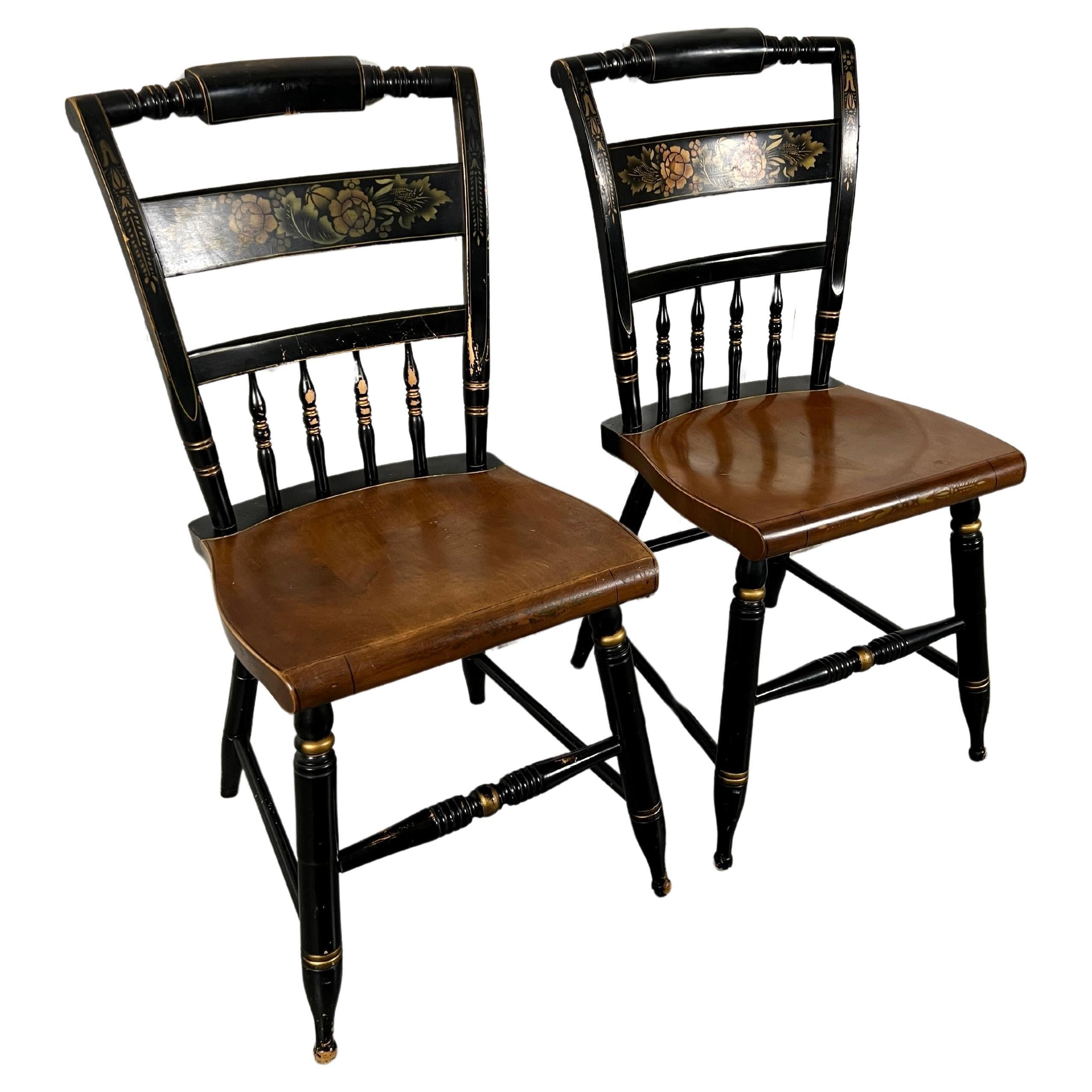 Late 20th century Hitchcock style chairs. These are ebonized then hand stenciled with a Neo Classicial design. Very sturdy.