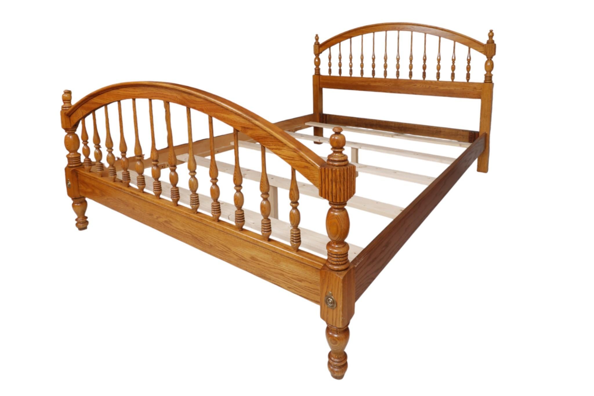 Una struttura letto matrimoniale in stile Hitchcock realizzata in Oak. La testiera e la pediera ad arco sono sostenute ciascuna da dodici fusi finemente torniti, rifiniti da una base tornita ad alveare. I montanti d'angolo sono rifiniti con un