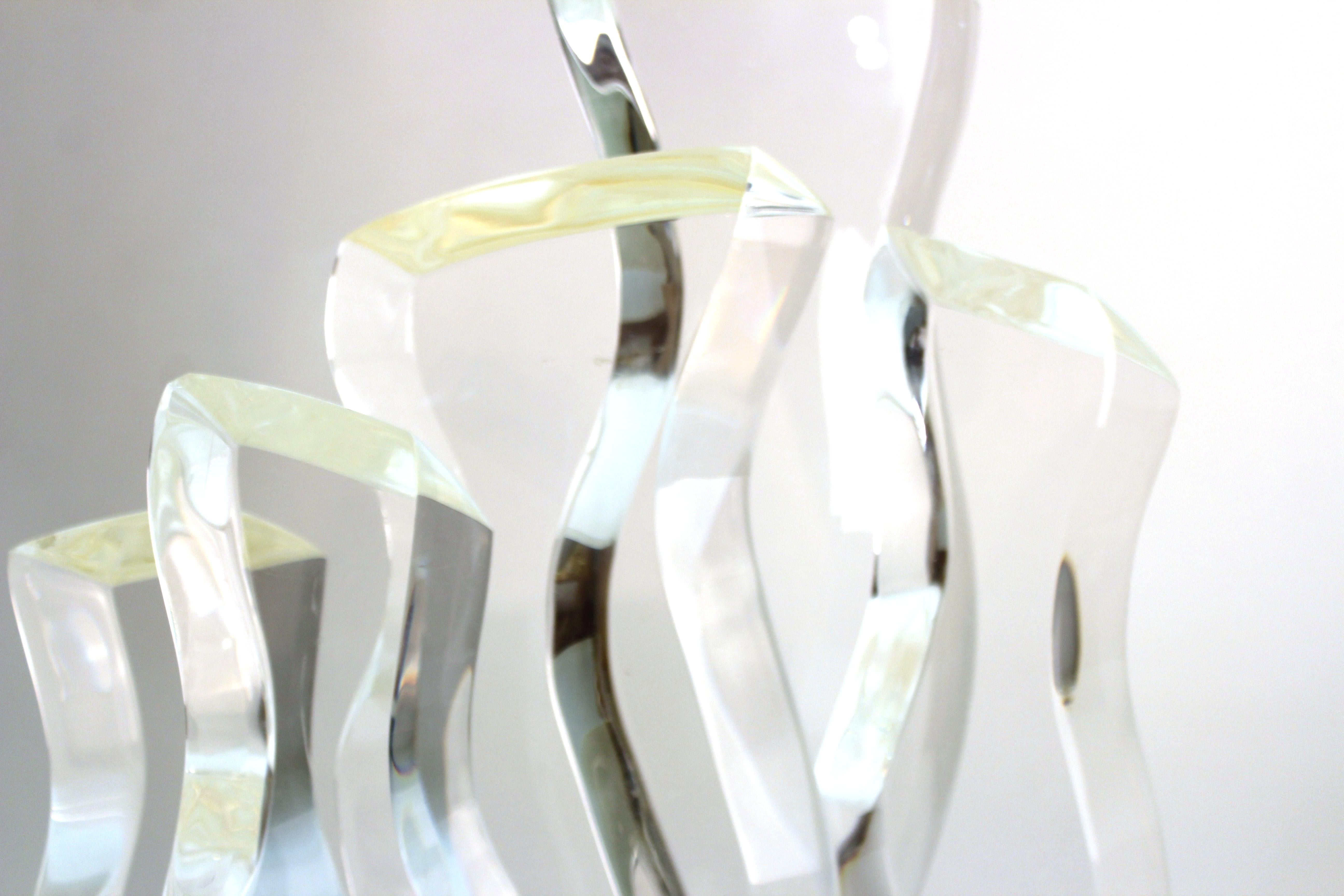 Mid-Century Modern abstract Lucite sculpture designed by Hivo Van Teal in the shape of wave elements rising from a base. The piece is signed by the maker on one of the corners of the base and is in great vintage condition with age-appropriate wear.