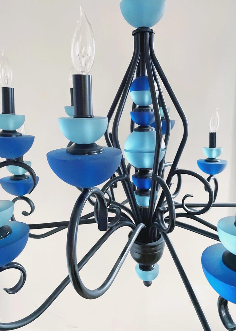 Vintage wrought iron Hivo Van Teal chandelier featuring handcrafted juicy blue lucite and twelve handmade gold gilt paper shades that are still in their original wrapping. Measures 32.5” tall, 34” wide and has a 40” chain. Shades are 4.5” in height