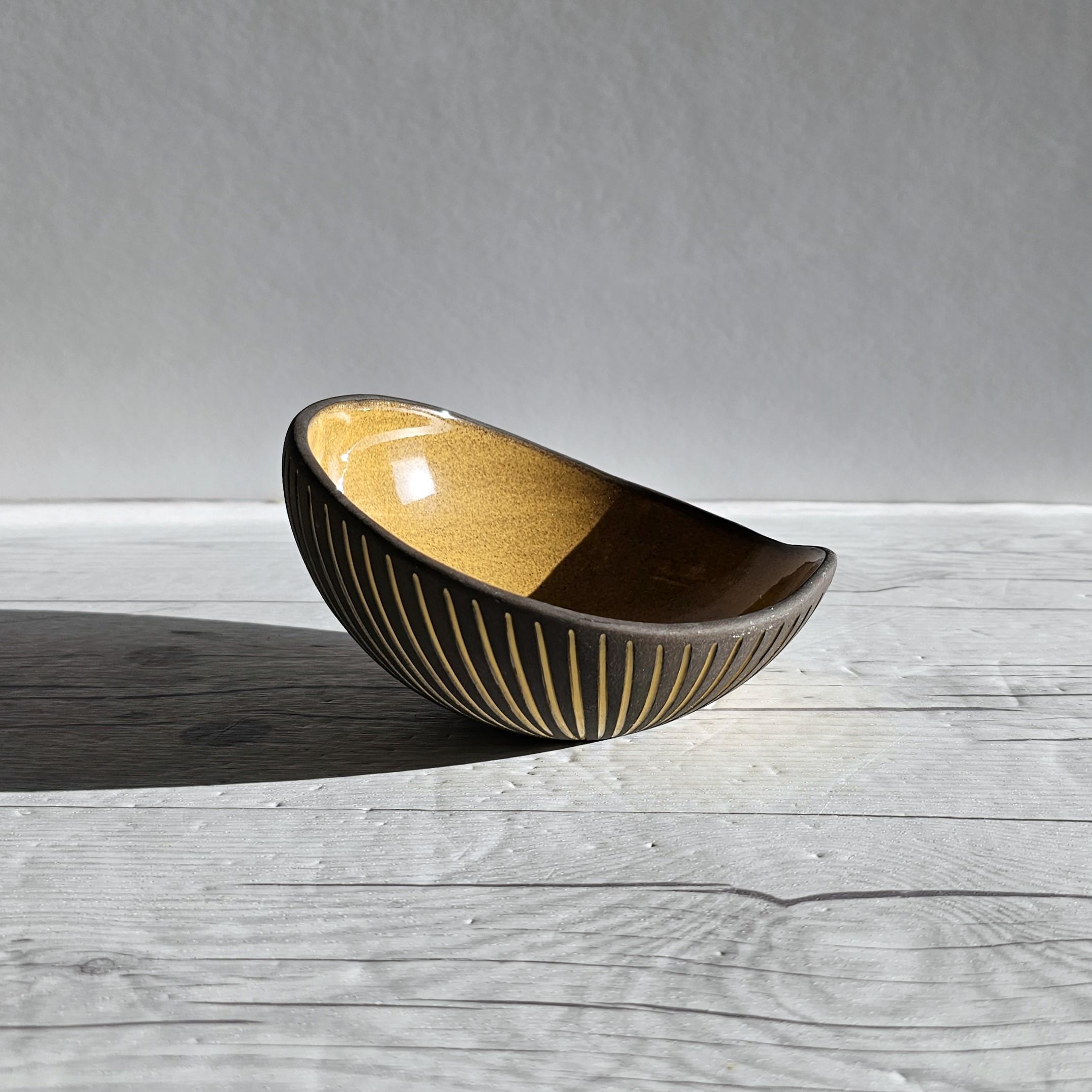 This elegant work of Swedish Mid Century Modern design is by Hjördis Oldfors (b. 1920 - d. 2014) for Upsala Ekeby. Oldfors was a celebrated Swedish ceramicist, painting, and textile artist, known for many series she designed at Upsala Ekeby which