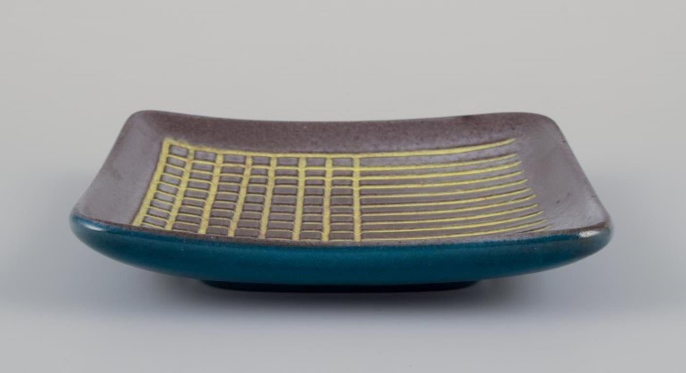 Swedish Hjördis Oldfors for Upsala Ekeby. Ceramic tray in yellow, brown, and blue tones For Sale