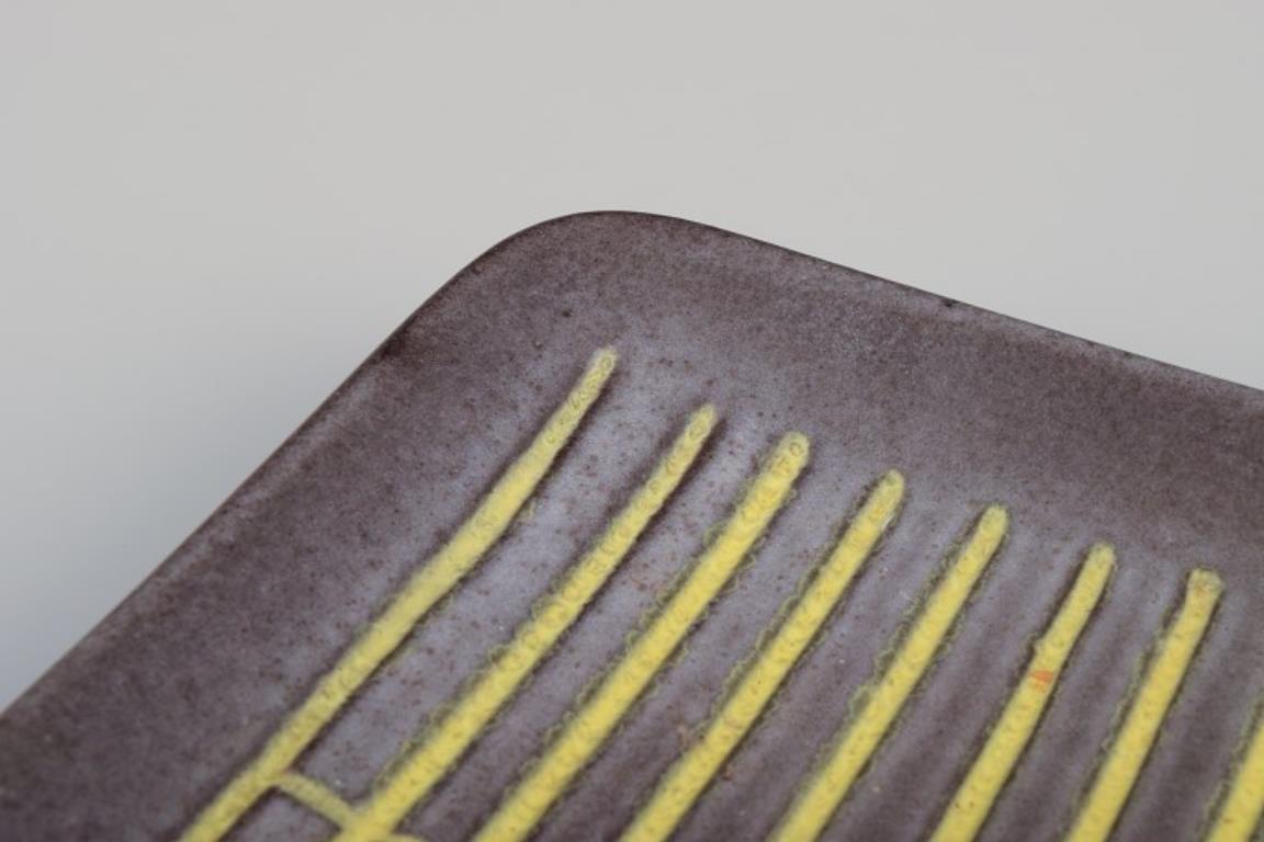 Glazed Hjördis Oldfors for Upsala Ekeby. Ceramic tray in yellow, brown, and blue tones For Sale