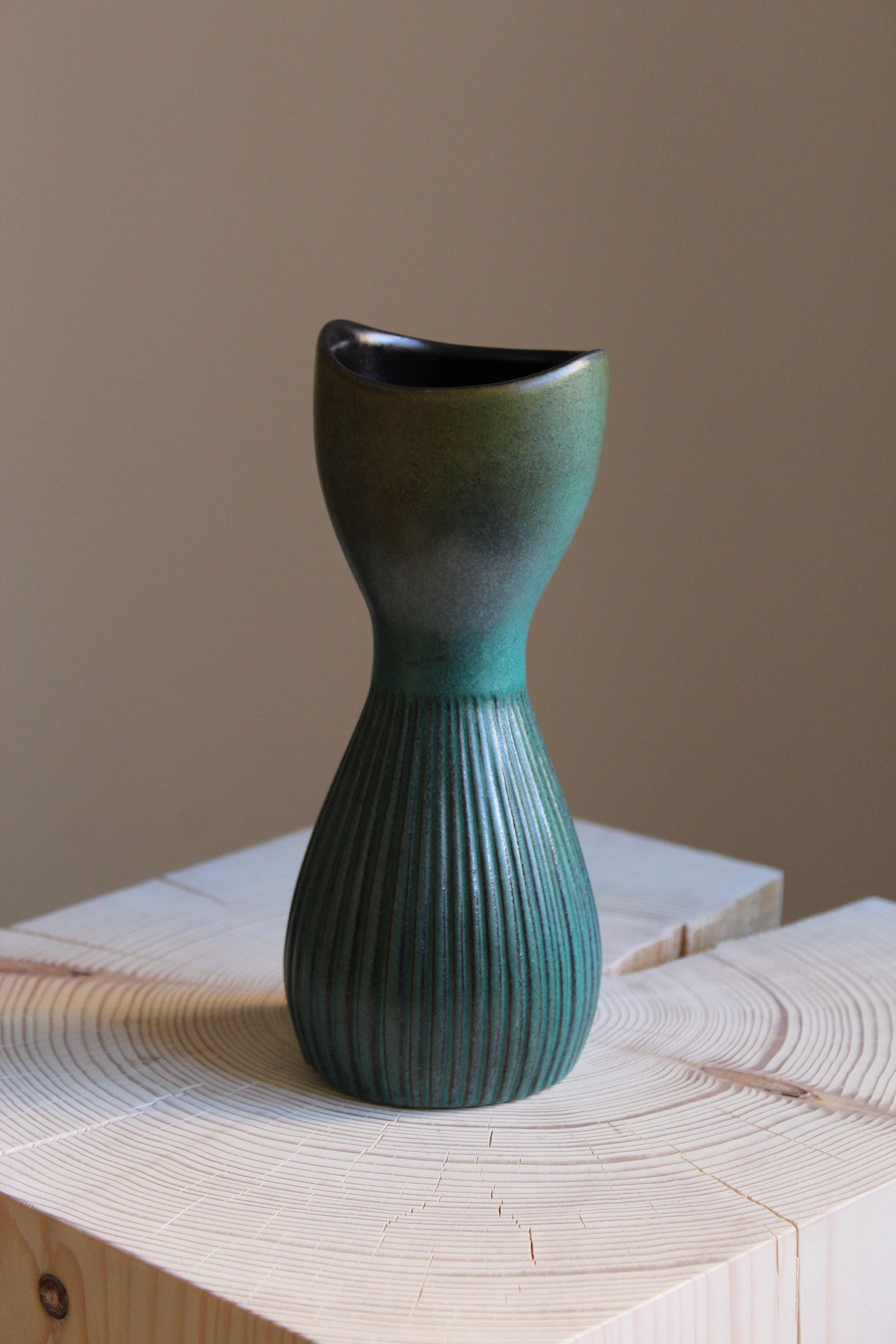 A vase. Designed by Hjördis Oldfors, for Upsala-Ekeby, Sweden, 1950s-1960s

Other designers of the period include Ettore Sottsass, Carl Harry Stålhane, Lisa Larsson, Axel Salto, and Arne Bang.