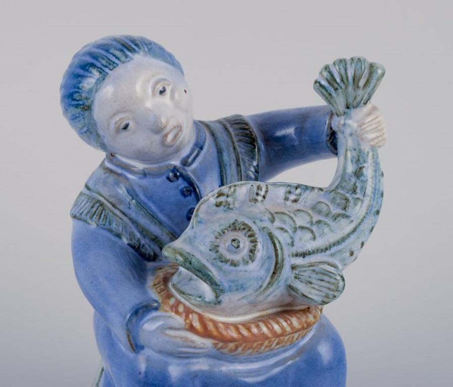 Glazed Hjorth, Bornholm, Denmark, fisherwoman figurine in glazed ceramic. Mid-20th C. For Sale