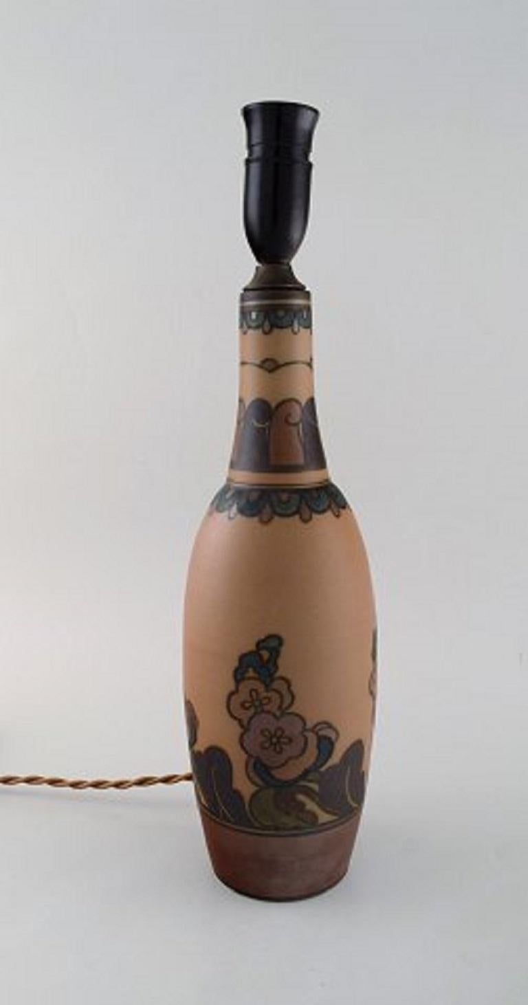 Hjorth, Denmark. Art Nouveau glazed ceramic lamp with floral motifs, early 20th century.
Measures: 35.5 x 11.5 cm (excluding socket)
In very good condition.
Stamped.