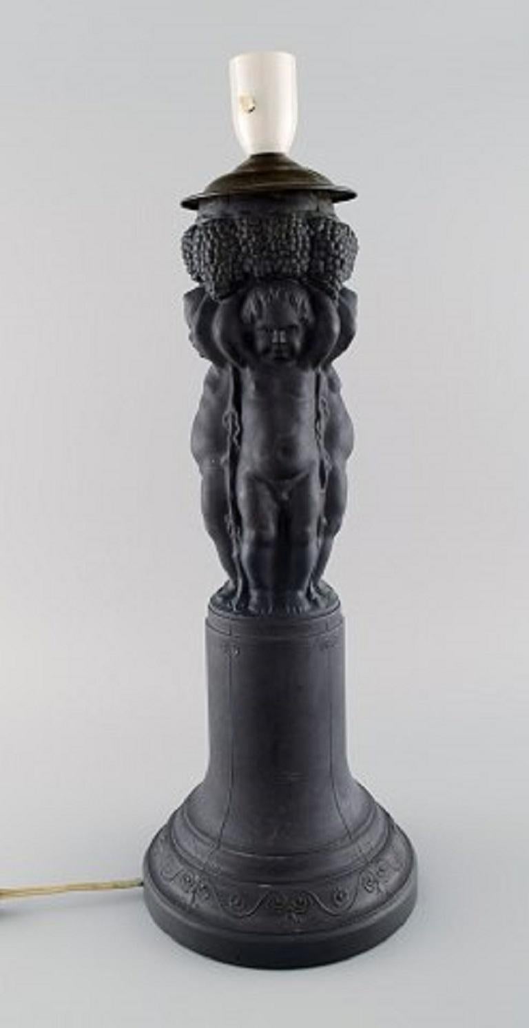 Hjorth, Denmark. Large lamp made of black terracotta decorated with putti and bunches of grapes, 1880s-1890s.
Measures: 45 x 18 (ex socket).
In very good condition.