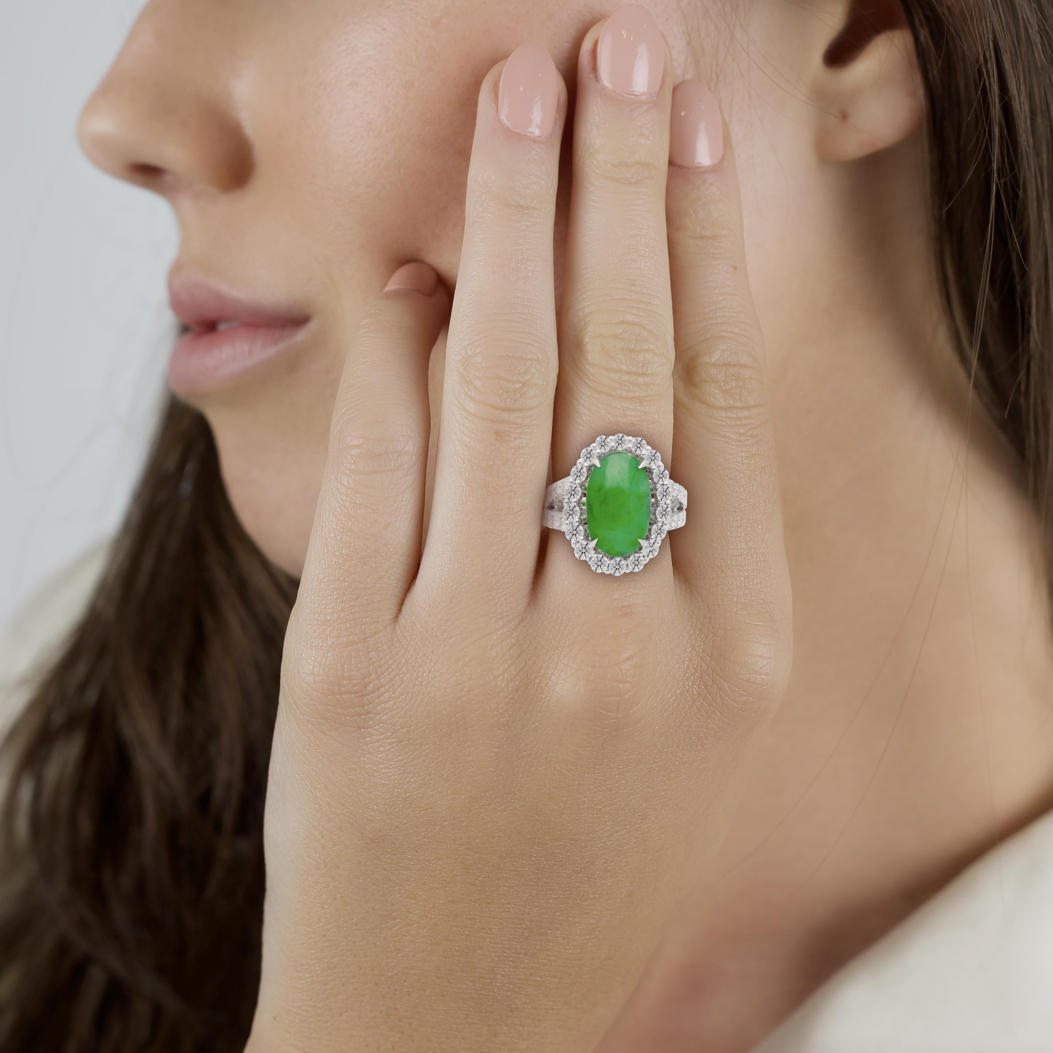 Jade and Diamond Halo Ring in 18K White Gold. 

A naturally beautiful piece, this ring exudes a 5.329-carat oval-cut jade center stone. The jade is certified by the Hong Kong Jade and Stone Laboratory. The jade is enhanced by additional diamond