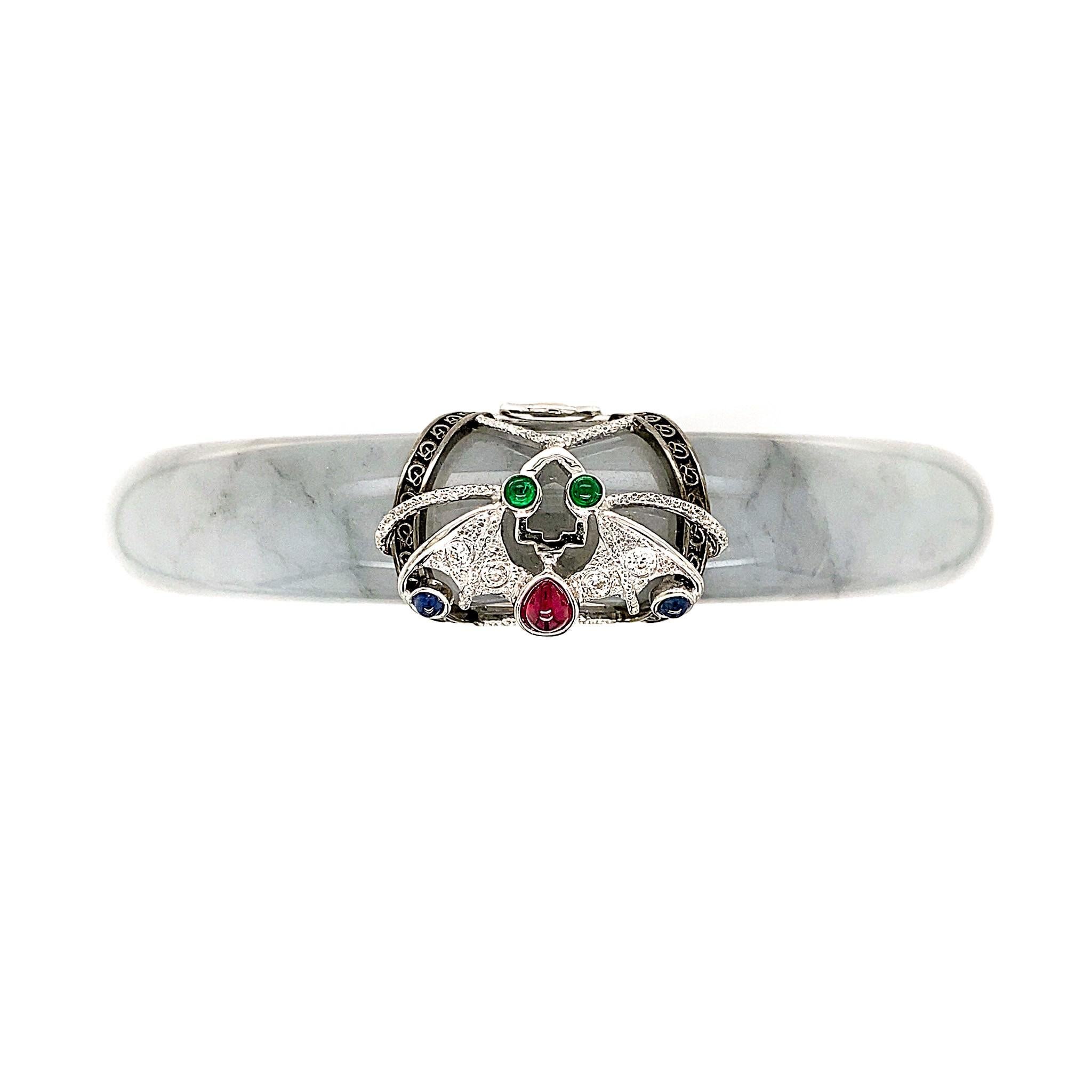 The House of Dilys’ presents – the Jade 'Nocturna' Bangle. This HKJSL certified 232.06cts natural jade with black and grey smoke-like inclusions is adorned with an 18K gold guard that takes on the Feng Shui symbol for prosperity and abundance – the