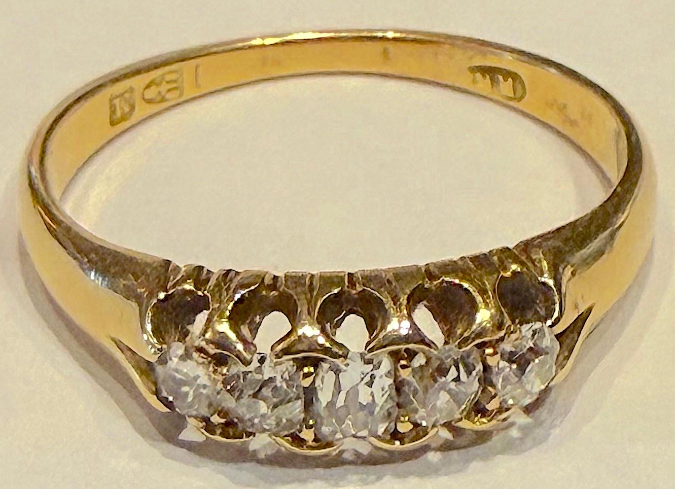 Because this 18K Five Stone cushion cut diamond  ring is hallmarked, 1895 Chester, you are guaranteed its authenticity.  The stones are graduated with the center stone weighing approximately 8 points.  The total weight is over 1/3 carat.  This would