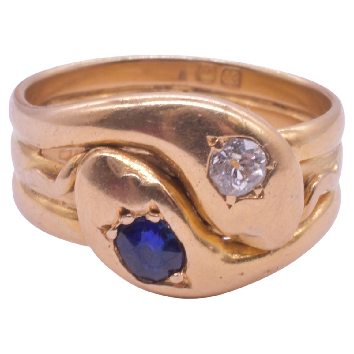 Striking 18K sapphire and diamond double snake ring fully hallmarked for London in 1914 and fabricated in 18K gold. Snake rings became popular in England when Queen Victoria received an emerald snake ring as her engagement ring from Prince Albert.