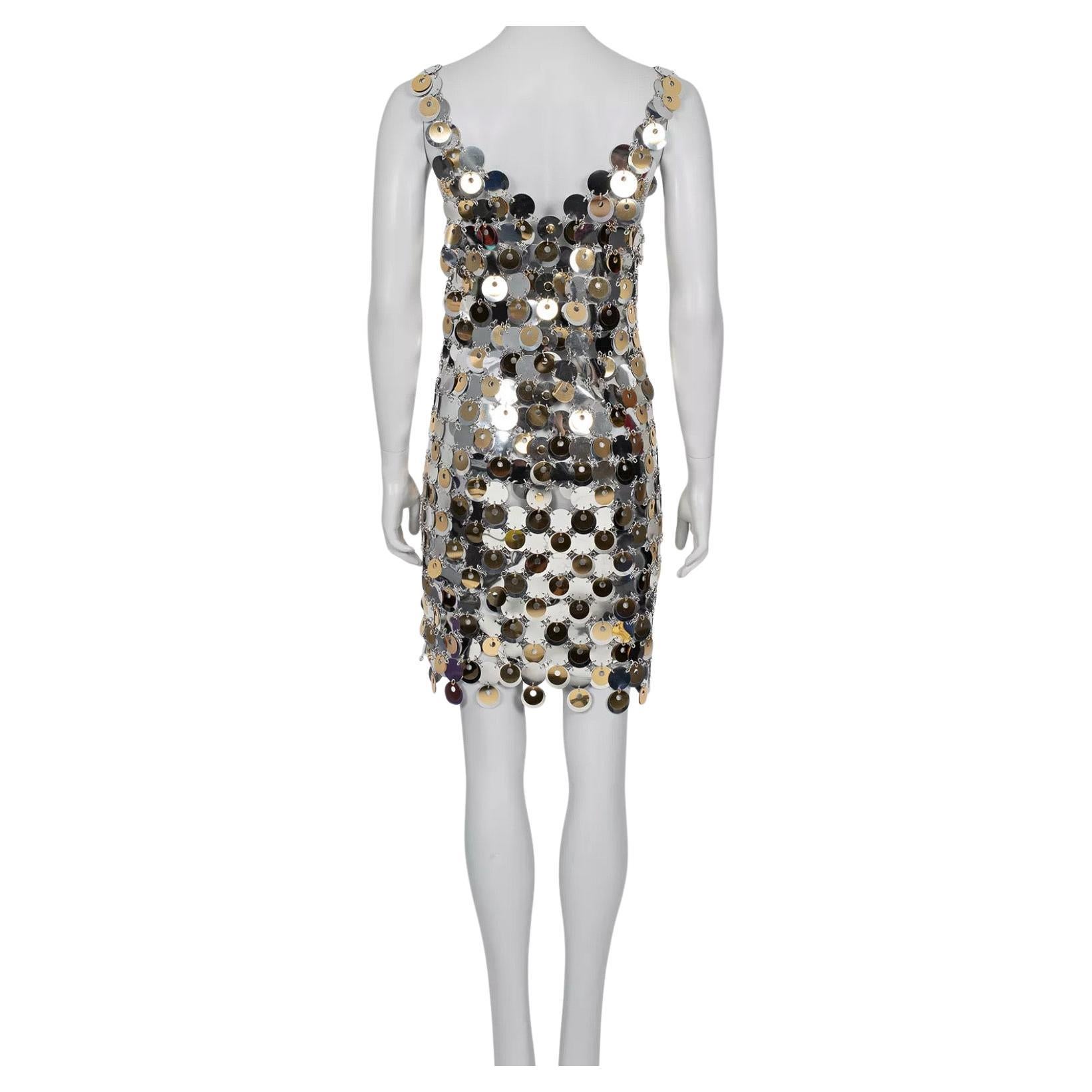 Elevate your wardrobe with this stunning H&M x Paco Rabanne silver sequin jacket! This collaboration piece features a straight cut design and eye-catching gold-tone hardware, blending futuristic aesthetics with accessible fashion. Perfect for adding