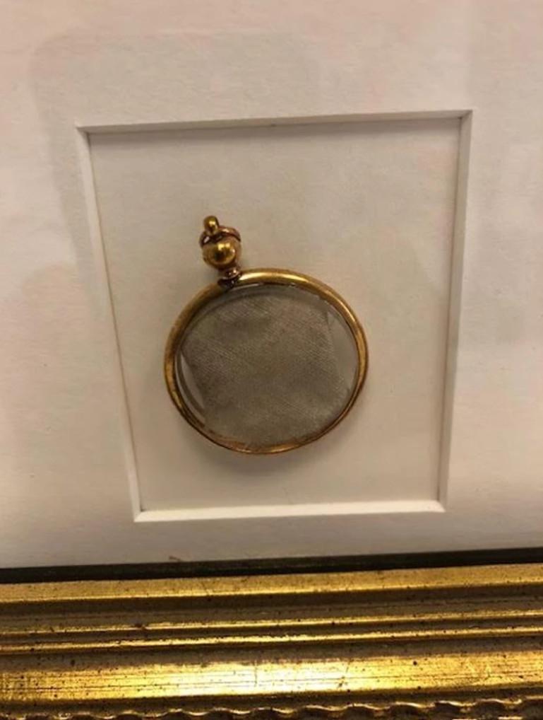 A 1 x 1 inch piece of the white ensign flag flown from the HMS Victory during the Battle of Trafalgar

Presented in an attractive Victorian-era gold colored locket on a portrait backing, complete with frame.

The HMS Victory, launched in 1765,