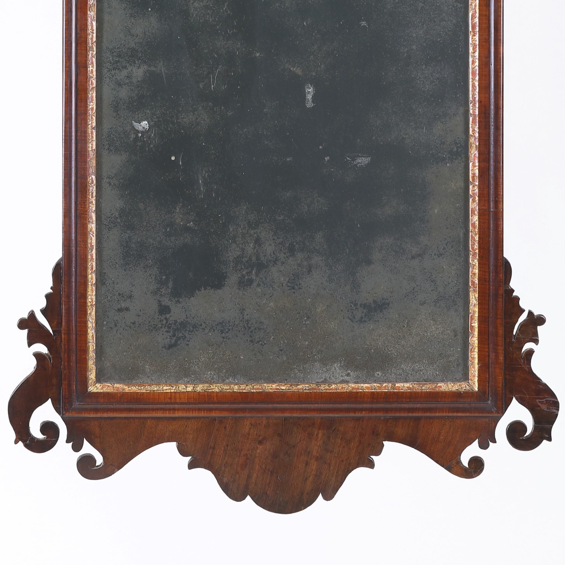 A fine mid-18th century fret-cut mahogany wall mirror with gilded Ho-ho bird crest and gilded sight edge. Retaining its' original distressed mirror plate with has a particularly pleasing tone and sparkle only found in 250 year-old glass.