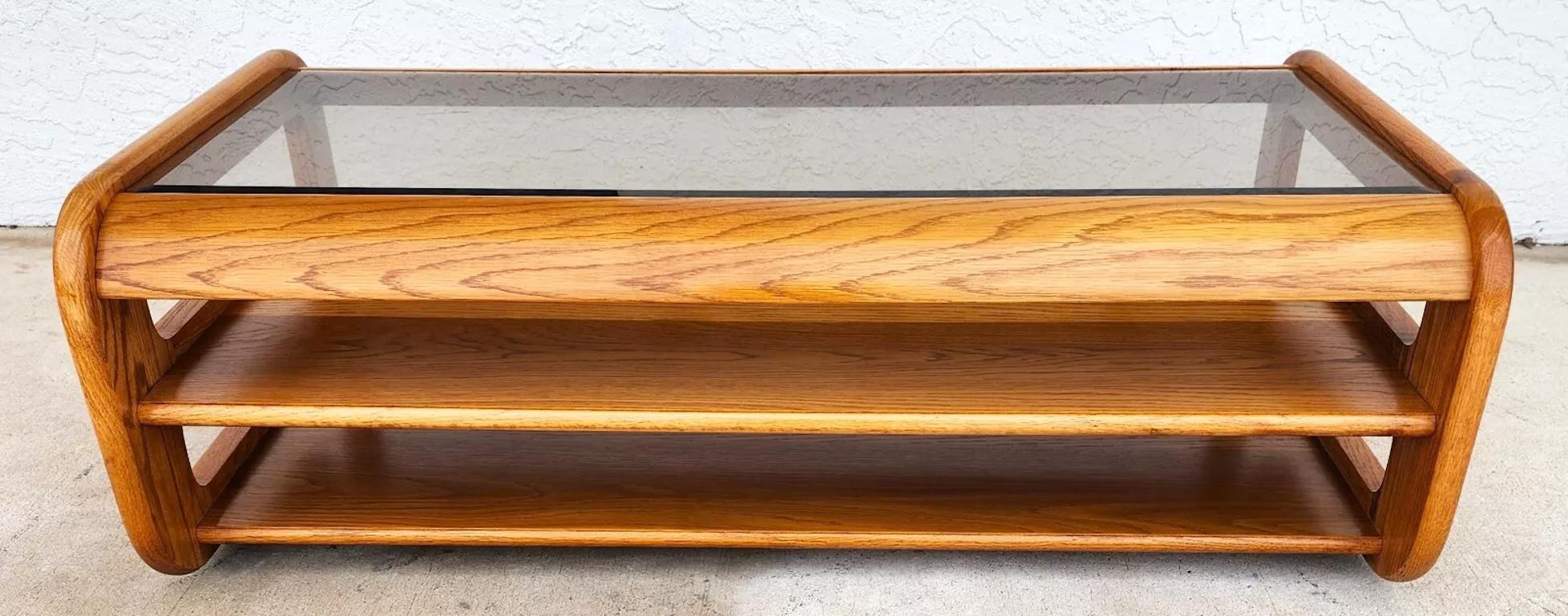 For FULL item description click on READ MORE below. 

Offering One Of Our Recent Palm Beach Estate Fine Furniture Acquisitions Of A
1970's Mid Century Modern Hodges Mersman Oak Smoked Glass Coffee Table

We also have 2 matching end tables and the