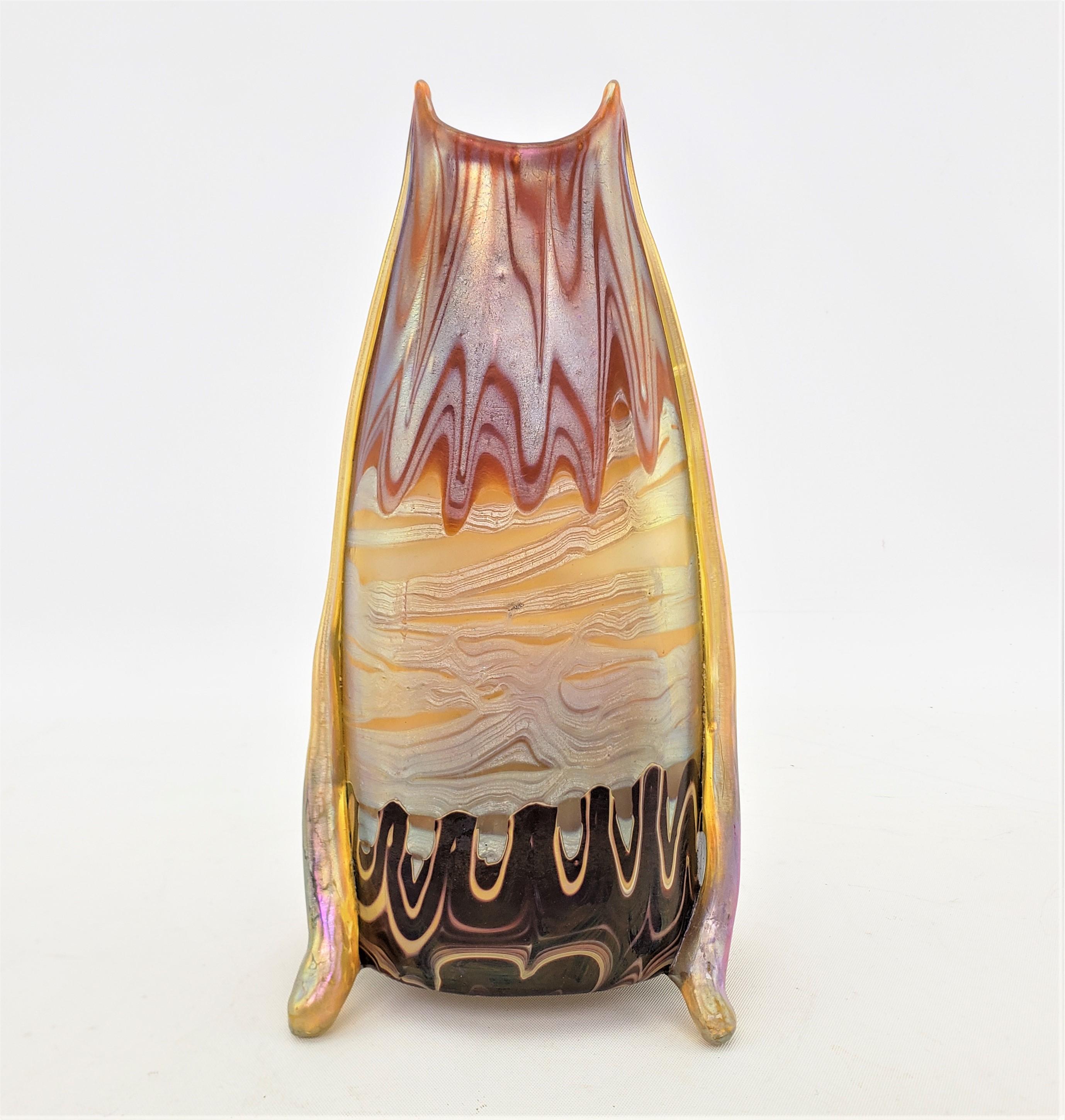 This very well exectued art glass vase was made by the renowned Loetz glass company of Austria in approximately 1900 in the period Art Nouveau style. This vase was designed by Hans Hofstoetter for Loetz and is done with his signature colors and