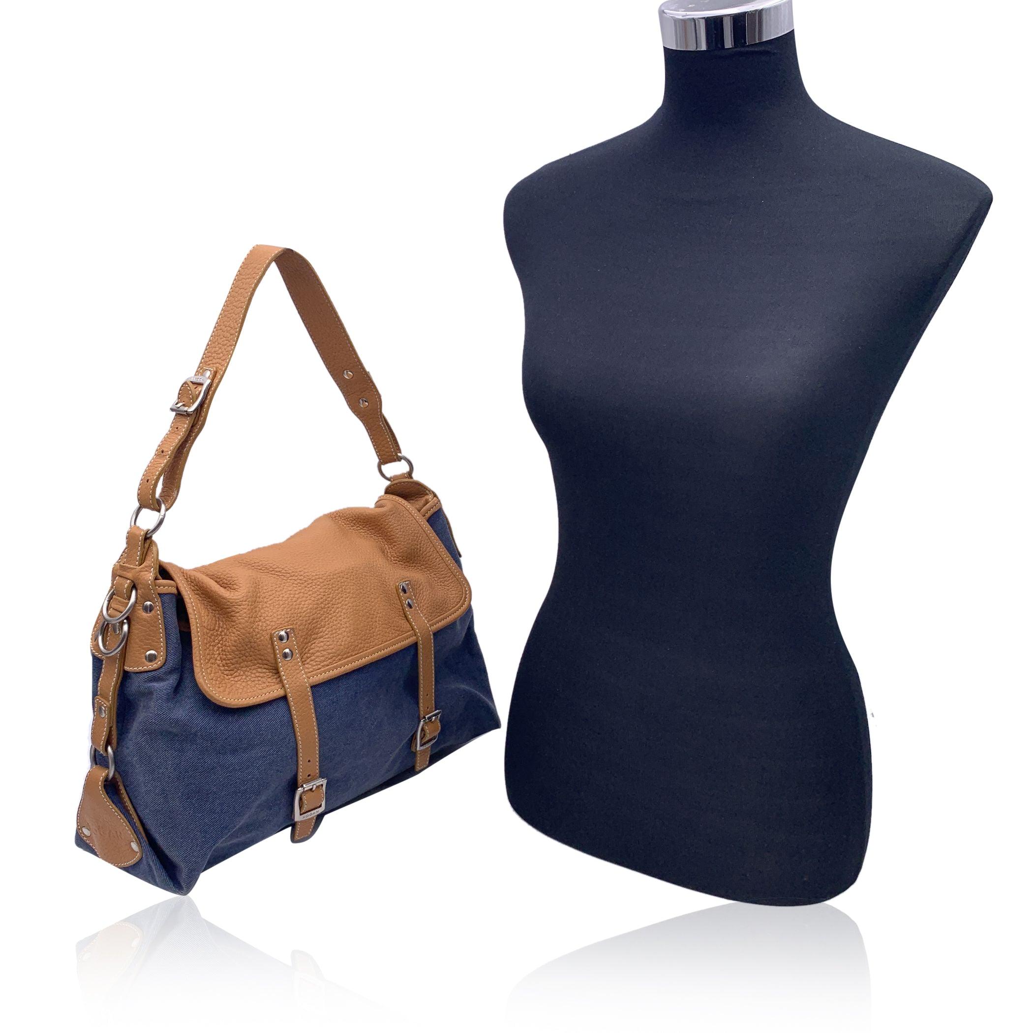 Hogan denim canvas shoulder bag tote with beige leather trim and shoulder strap. Flap with magnetic button closure and 2 buckle fasting on the front. Striped canvas lining. 1 side zip pocket and 1 side open pocket inside. 'HOGAN - Made in Italy' tag