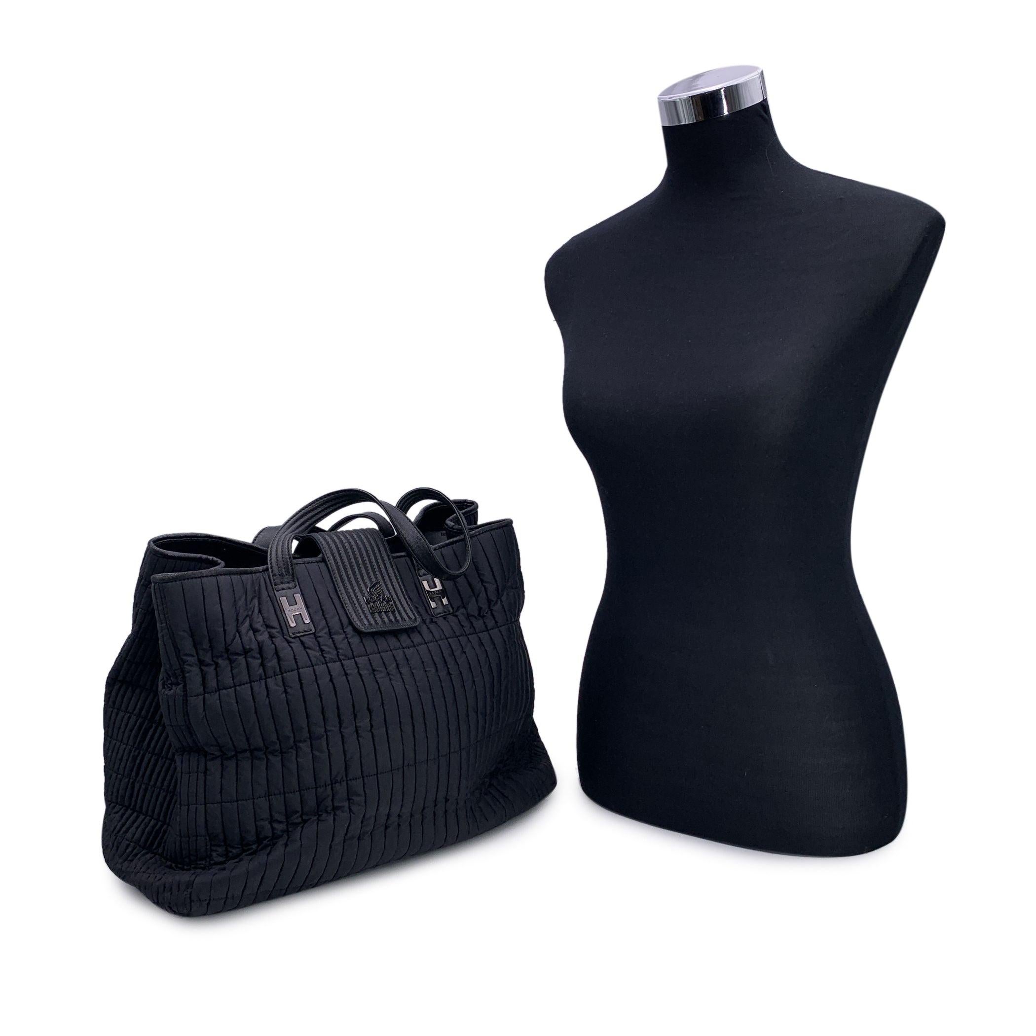 Elevate your everyday style with the Hogan by Karl Lagerfeld Black Nylon Kushion Shoulder Bag Tote, a chic and practical piece that seamlessly blends modern design with Italian craftsmanship. Manufactured in Italy between 2010 and 2019, this