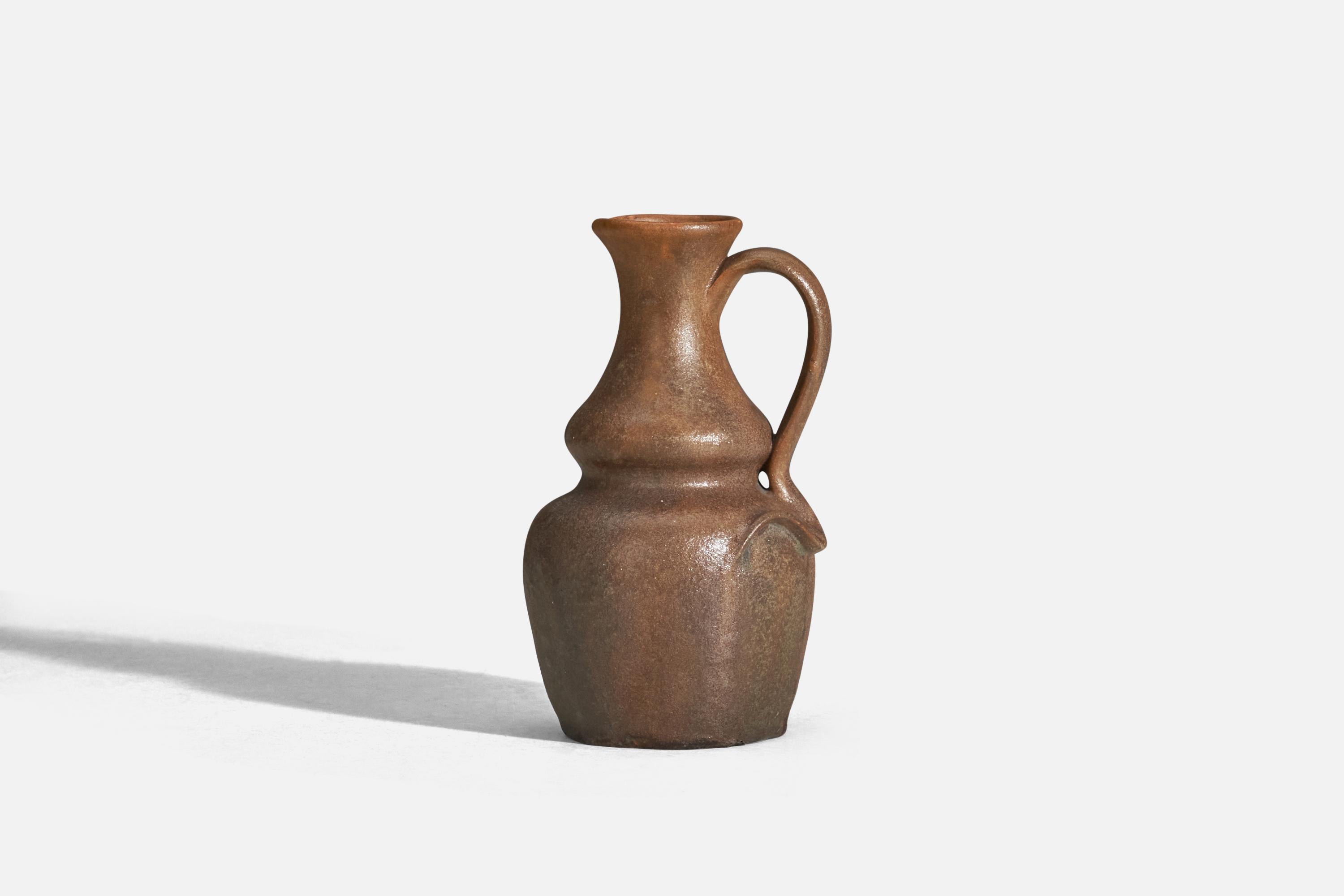 A brown glazed earthenware pitcher designed and produced by Höganas Keramik, Sweden, 1920s.

