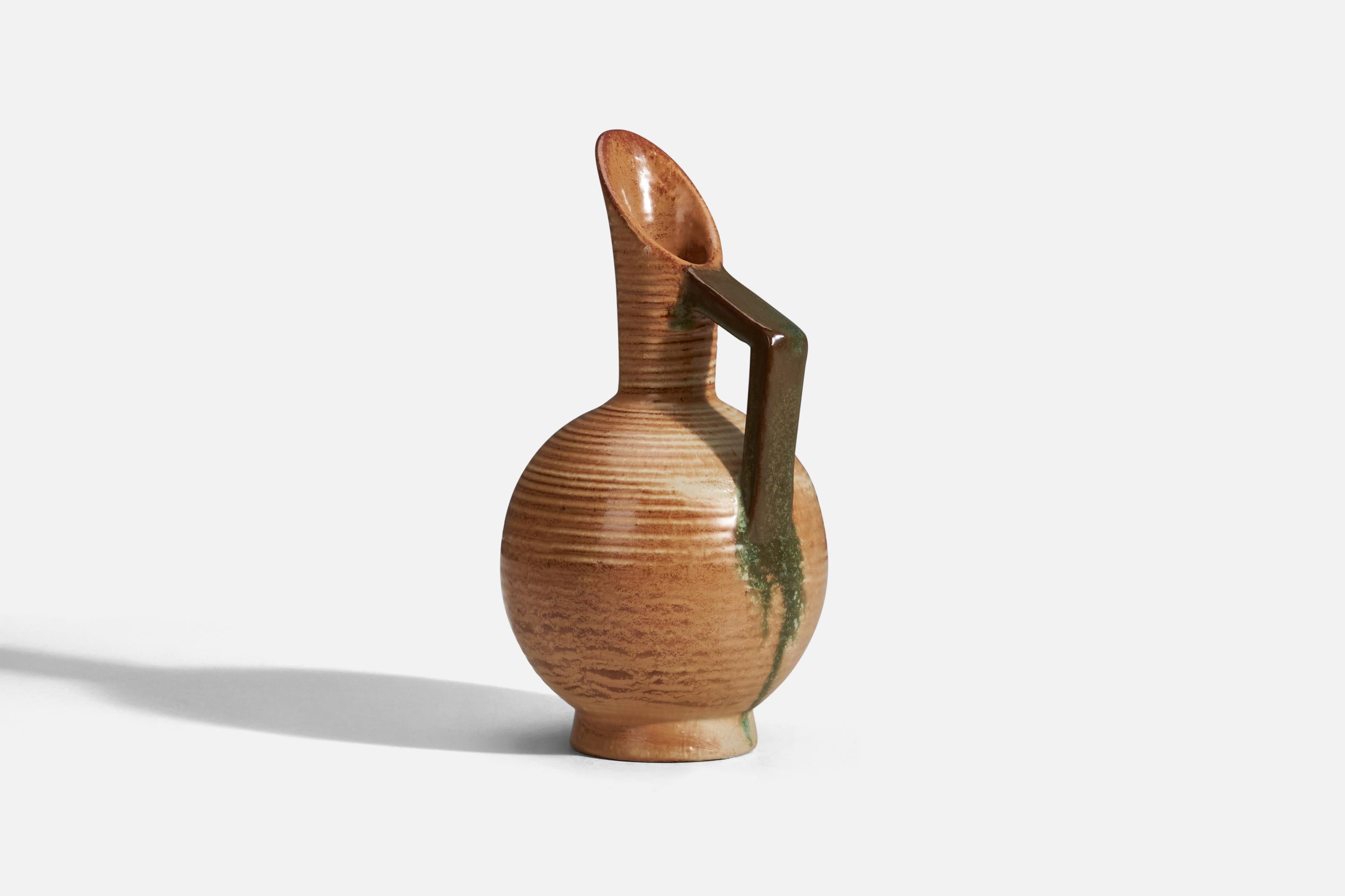 A brown and green glazed stoneware pitcher designed and produced by Höganas Keramik, Höganäs, Sweden, 1930s.