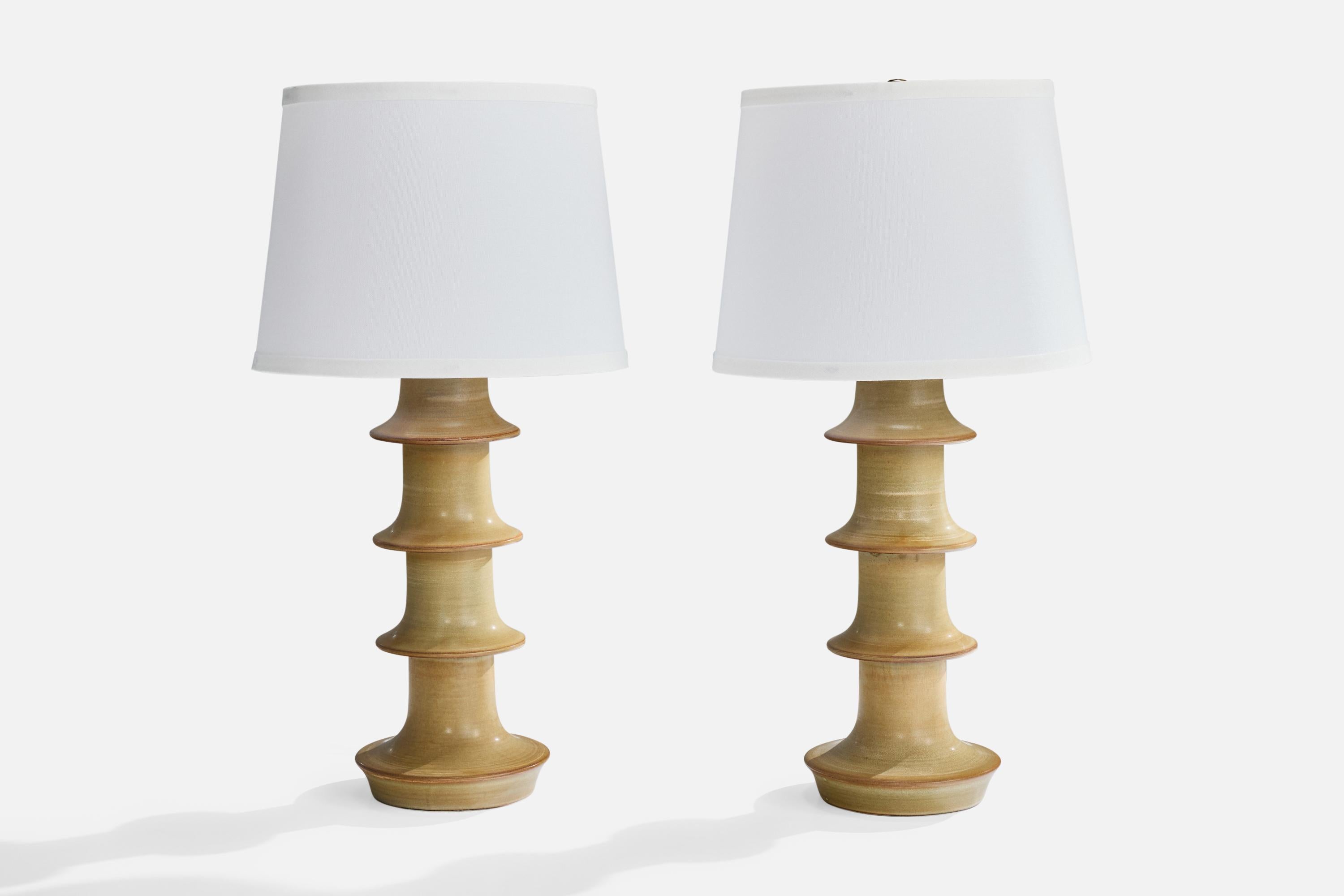 A pair of beige-glazed stoneware table lamps produced by Höganäs Keramik in partnership with Fagerhults Belsyning, Sweden, c. 1960s.

Wear consistent with age and use

Dimensions of Shade (inches): 10” Top Diameter x 12” Bottom Diameter x 9”