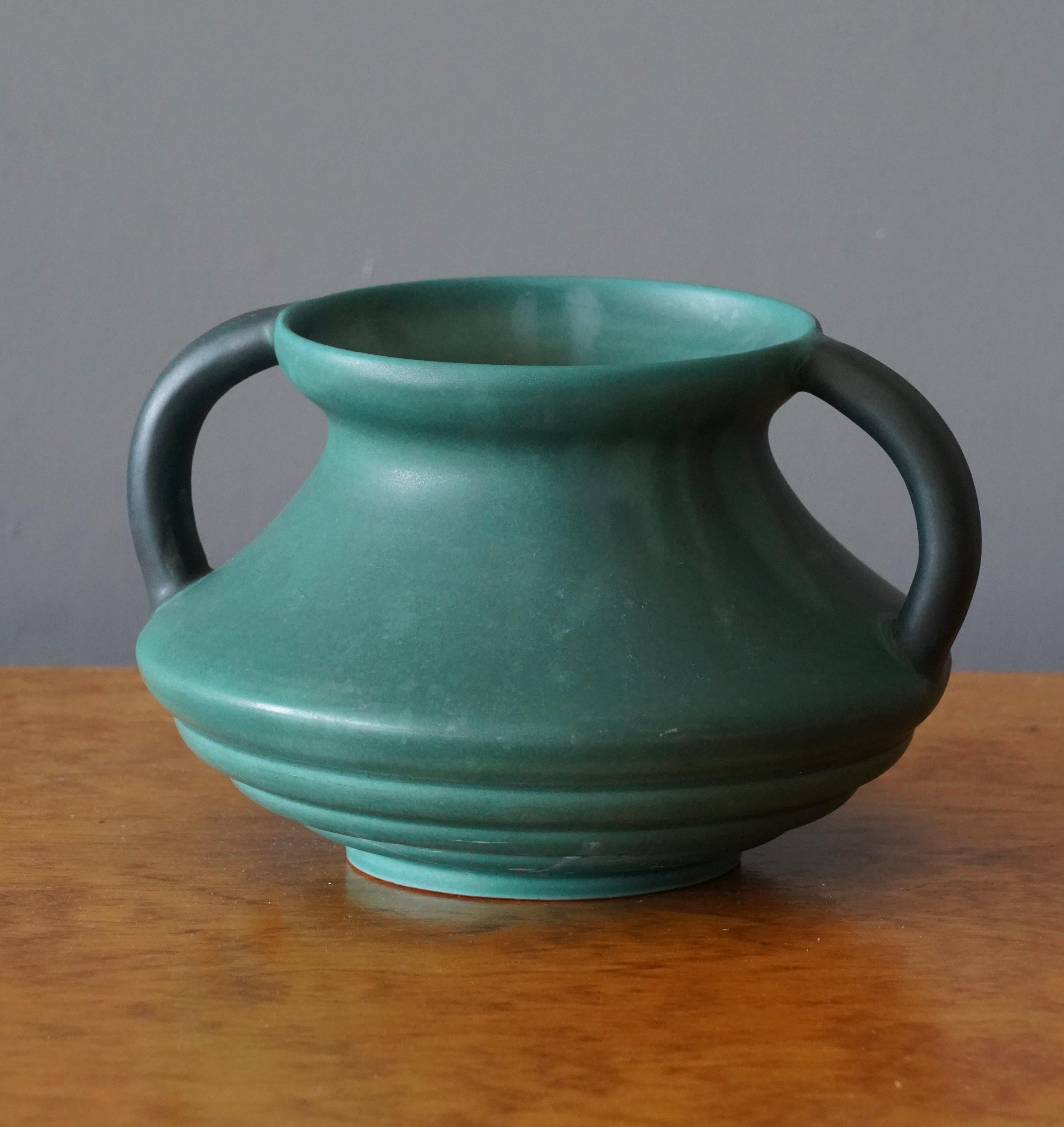 An early vase, by Höganäs Keramik. In green glazed earthenware. Designed and produced in Höganäs, Sweden, c. 1940s.

Marked and labeled to underside. 



 