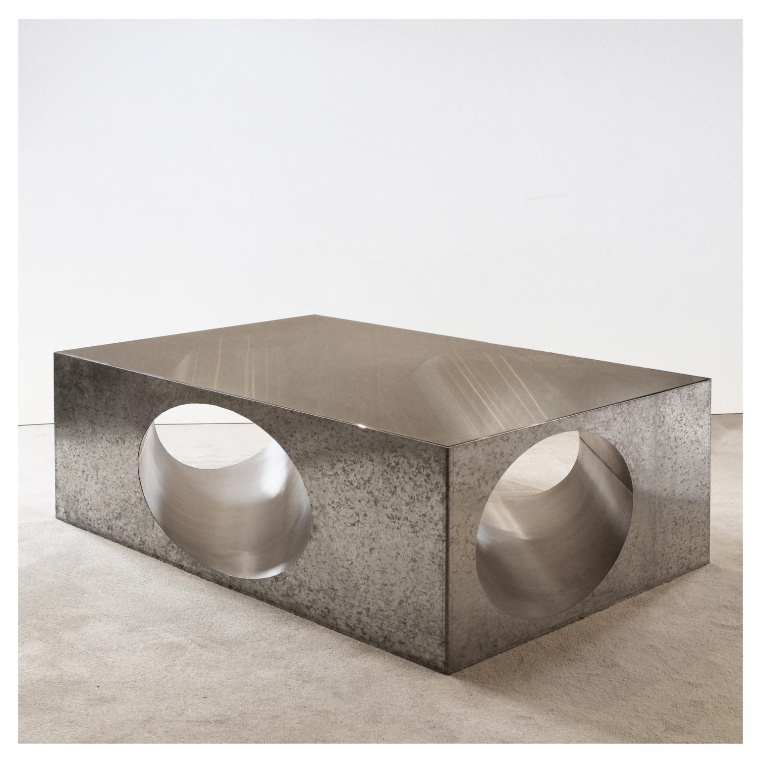 Hol-low table by Christian Zahr
Dimensions: W 120 x D 80 x H 40 cm
Materials: Galvanised steel- stainless steel- tainted glass

Each piece is handmade.

Christian Zahr studied architecture at the Academie Libanaise des Beaux Arts, Beirut,
