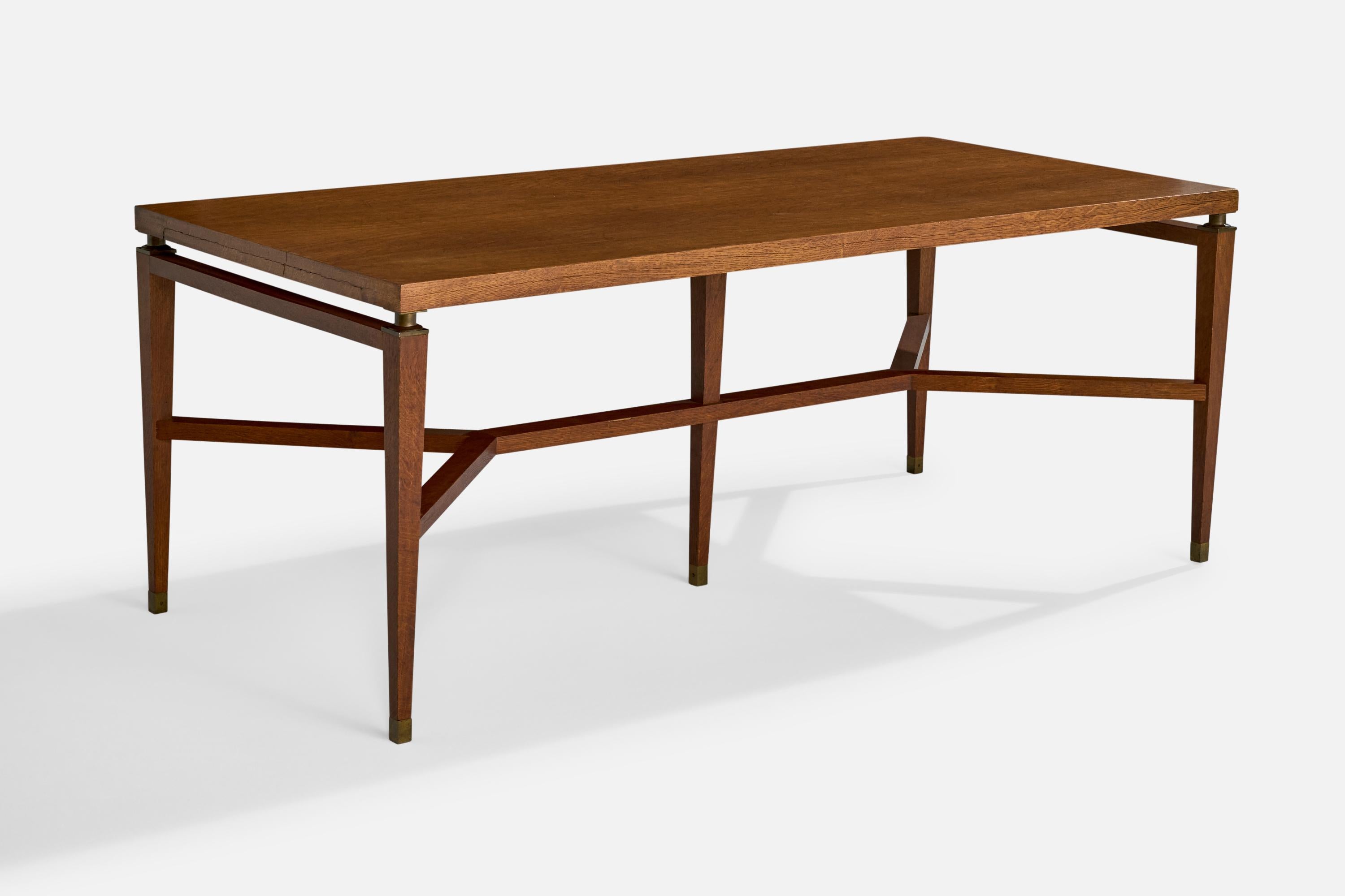 An oak and brass dining or center table designed by Holabird and Root and produced by Garland Furniture, USA, c. 1934.

The present table was designed for the Administration Building and the Superintendents Residence at the Morton Arboretum in