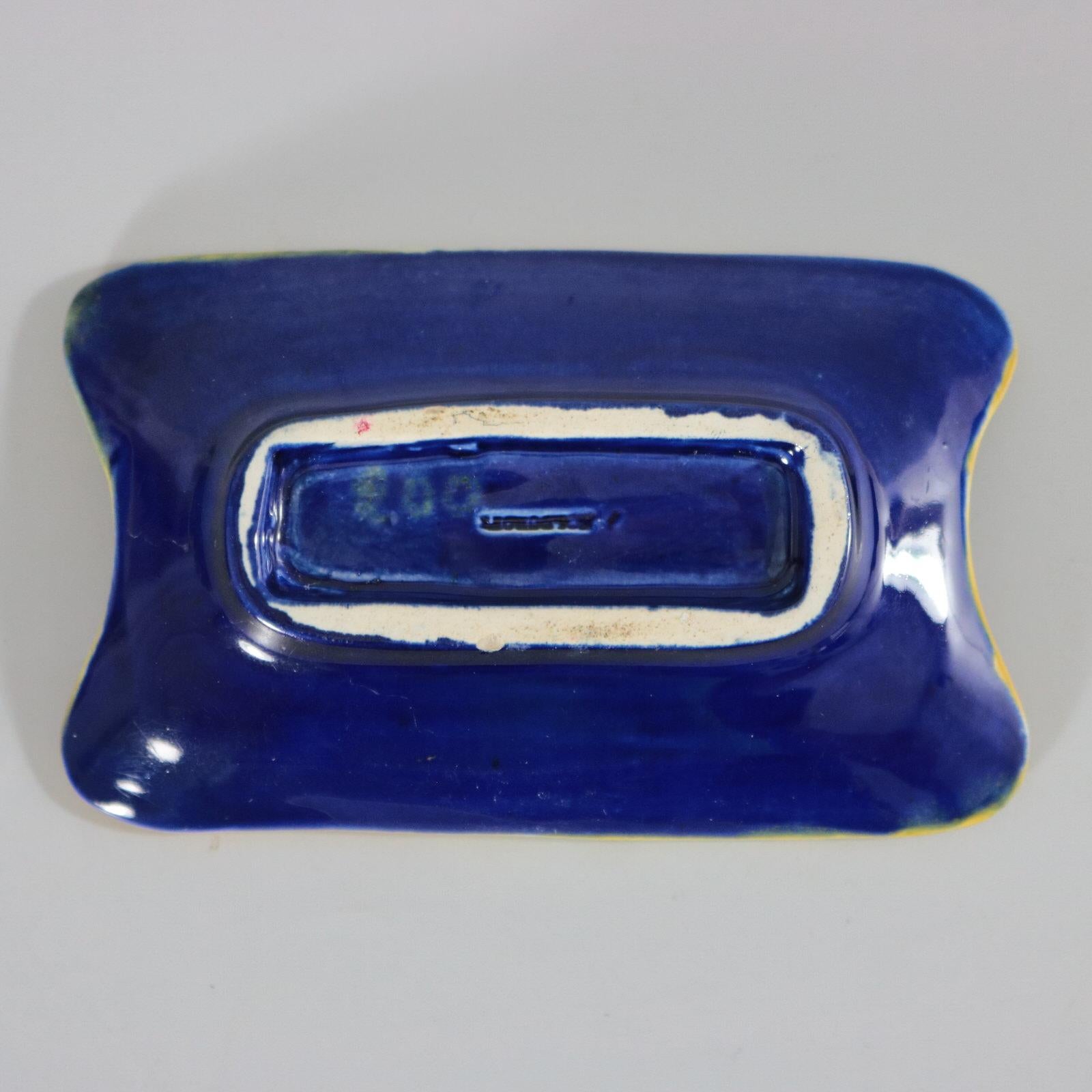 Holdcroft Majolica pin tray which features a flowering thorny twig on each corner. Colouration: cobalt blue, yellow, white, are predominant. The piece bears maker's marks for the Holdcroft pottery.