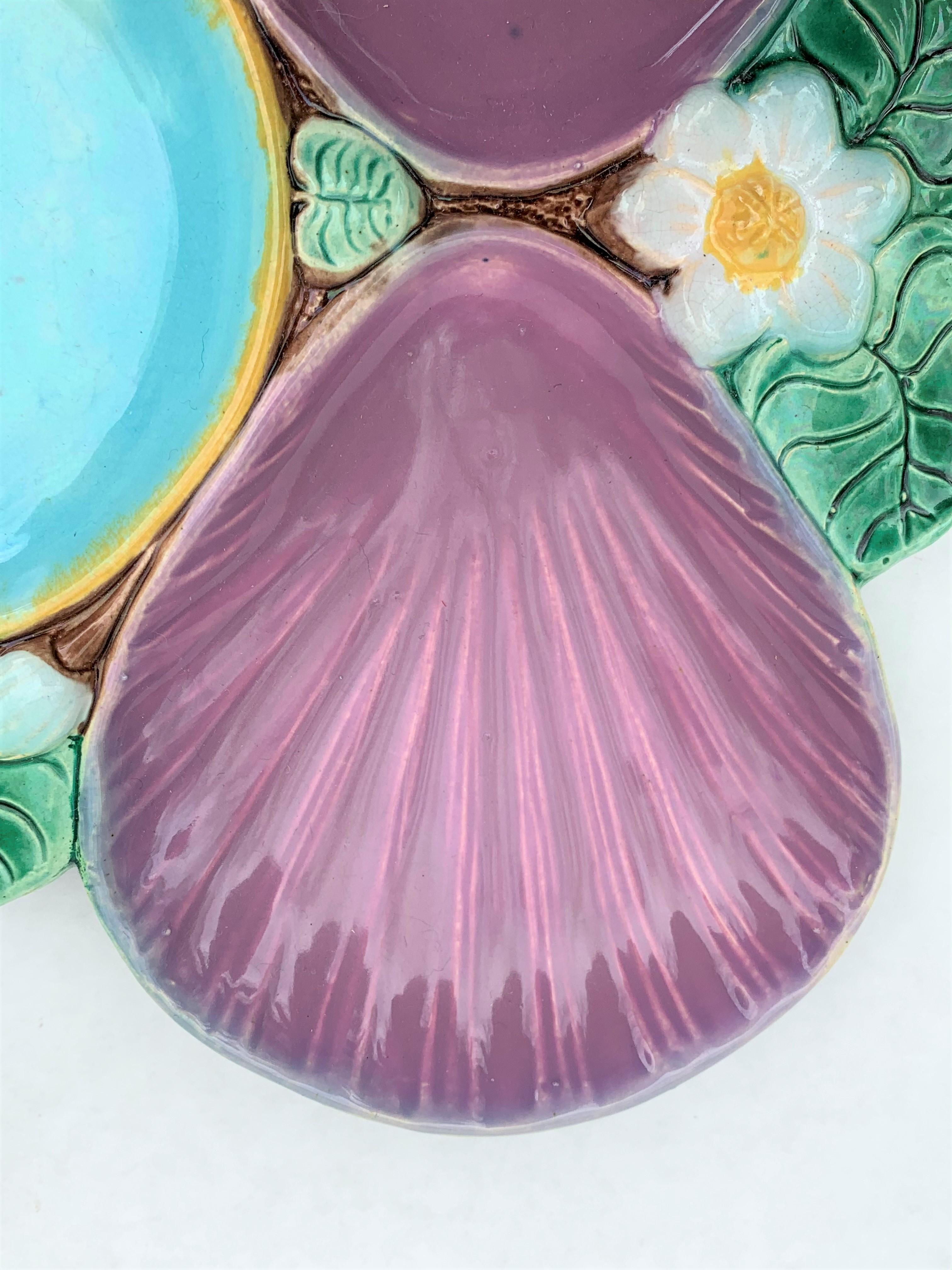 Holdcroft Majolica oyster plate, English, circa 1875, Pond Lily pattern, the wells glazed in deep pink with a hue of lavender.
Outstanding coloration and condition. No damage, repair or restoration. An extraordinary example of this well-known