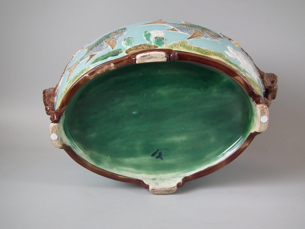 Holdcroft Majolica jardinière which features fish, water lily and blossom moldings. Colouration: turquoise, brown, green, are predominant.