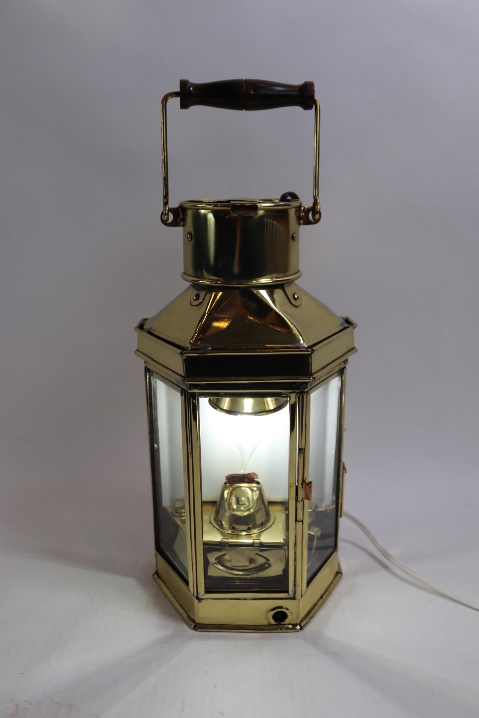 English style solid brass ships cabin lantern impressed with the name of Holder Stroud of Sydney. Also engraved 1941 with a pussers mark. Lantern is fitted with its original burner but has been fitted with an electric socket for home design. Some