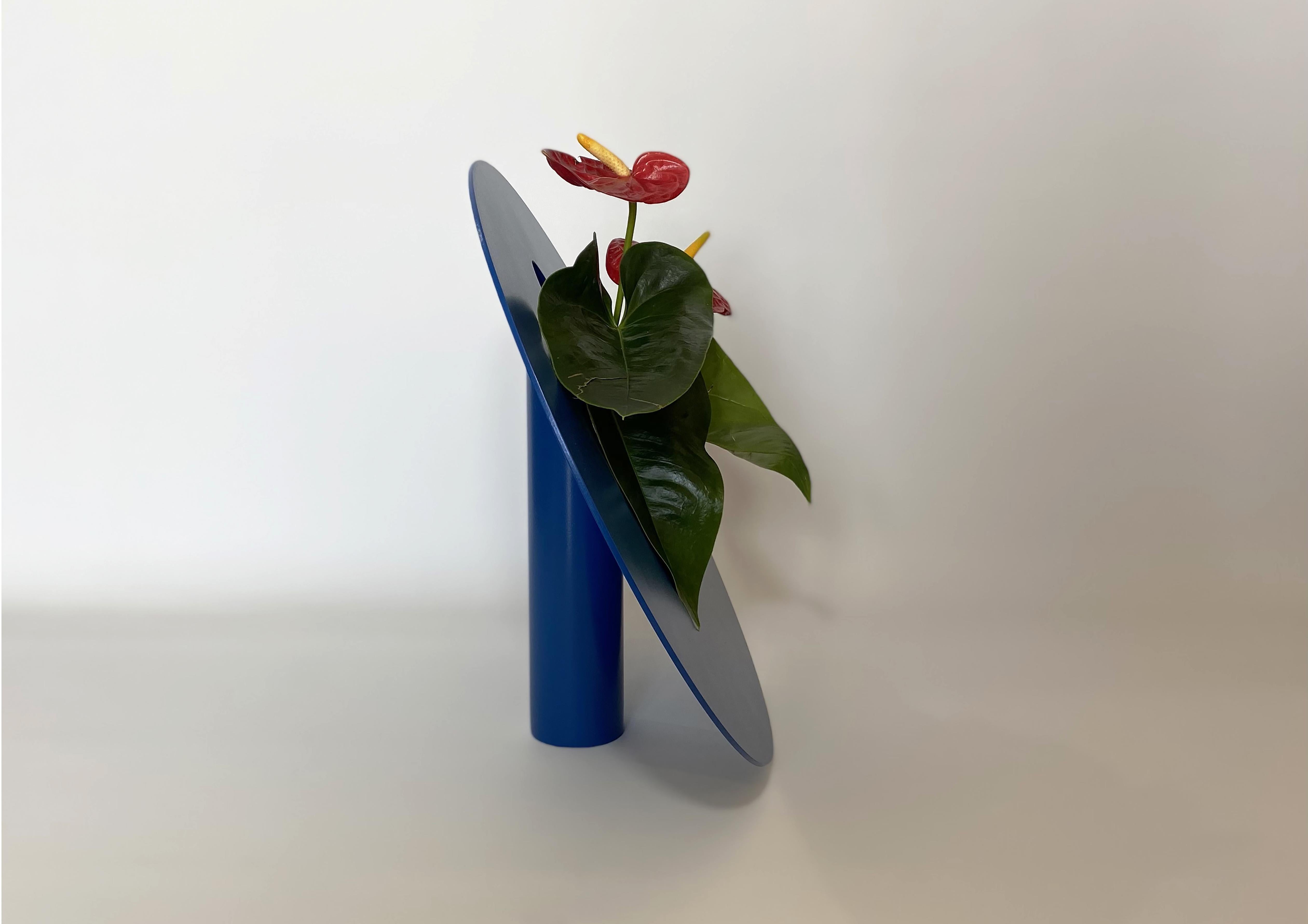 Hole dark blue vase by Shou.
Dimensions: D 40 x H 35 cm.
Materials: Stainless steel and electrostatic coated steel
Colour: dark blue

'Hole' vase inspired by the obscurity of the universe and black holes. The circular shape represents the
