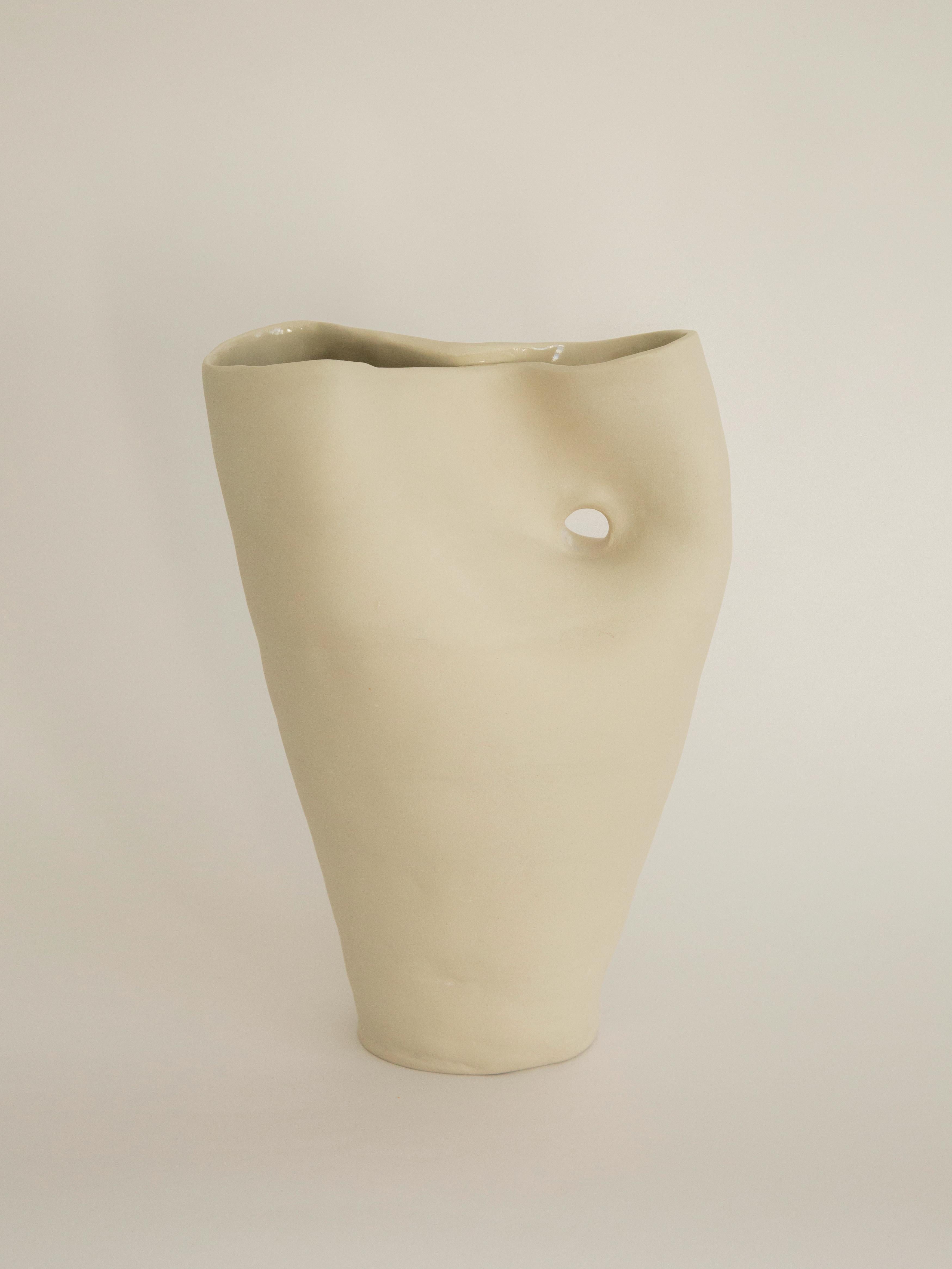 Hole Vase by Solem Ceramics
Dimensions: D 7.5 x W 20.5 x H 33 cm.
Materials: White stoneware, glaze.
This vase is water safe. Please contact us.

Solem’s work pulls from memories of the architecture and community within SWANA and Southeast Asia
