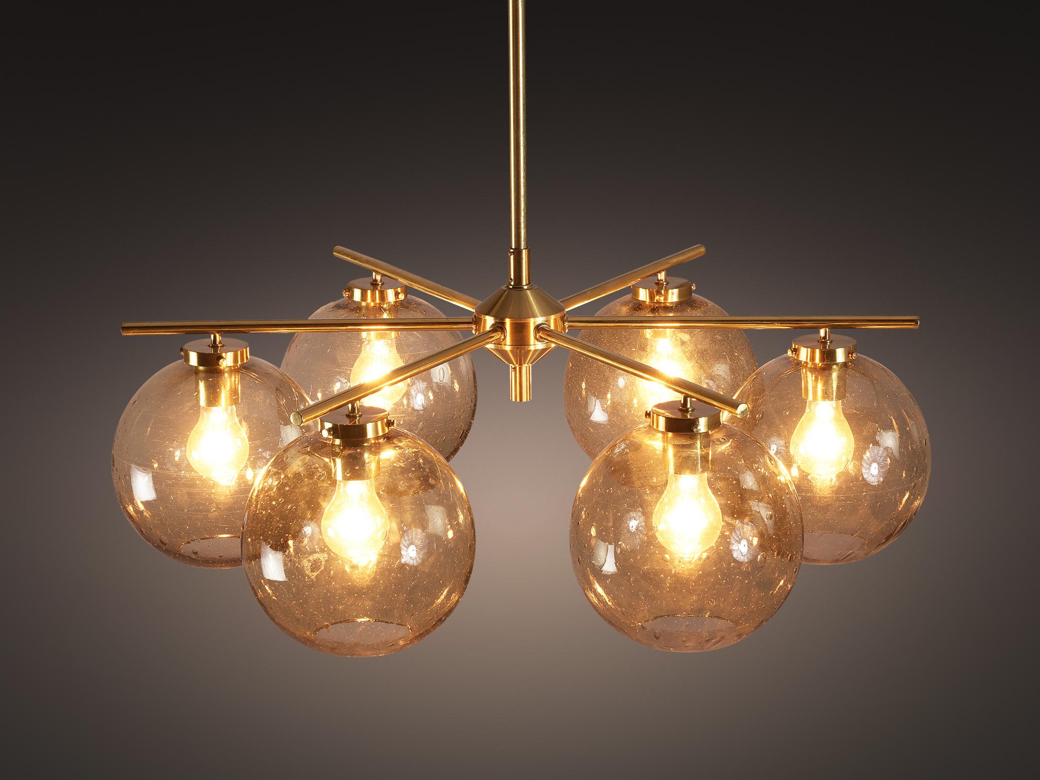 Holger Johansson for Westal, chandeliers, brass, smoked glass, Sweden, 1950s

These elegant and large chandeliers are designed by Swedish designer Holger Johansson in the 1950s. The brass frame is composed of six slender arms that hold the smoked