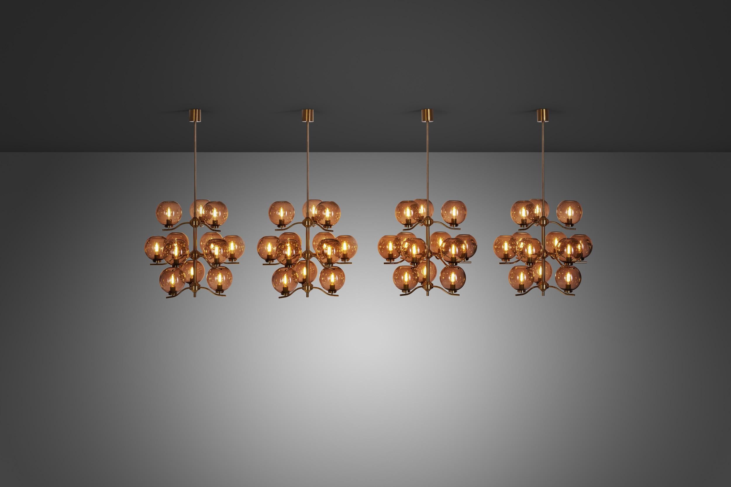 These marvellous chandeliers are a rarity from Swedish designer, Holger Johansson, who created them for his own company, Westal. With a brass frame holding 12 translucent bubble glass shades, grandiose and stylish are the words to describe these
