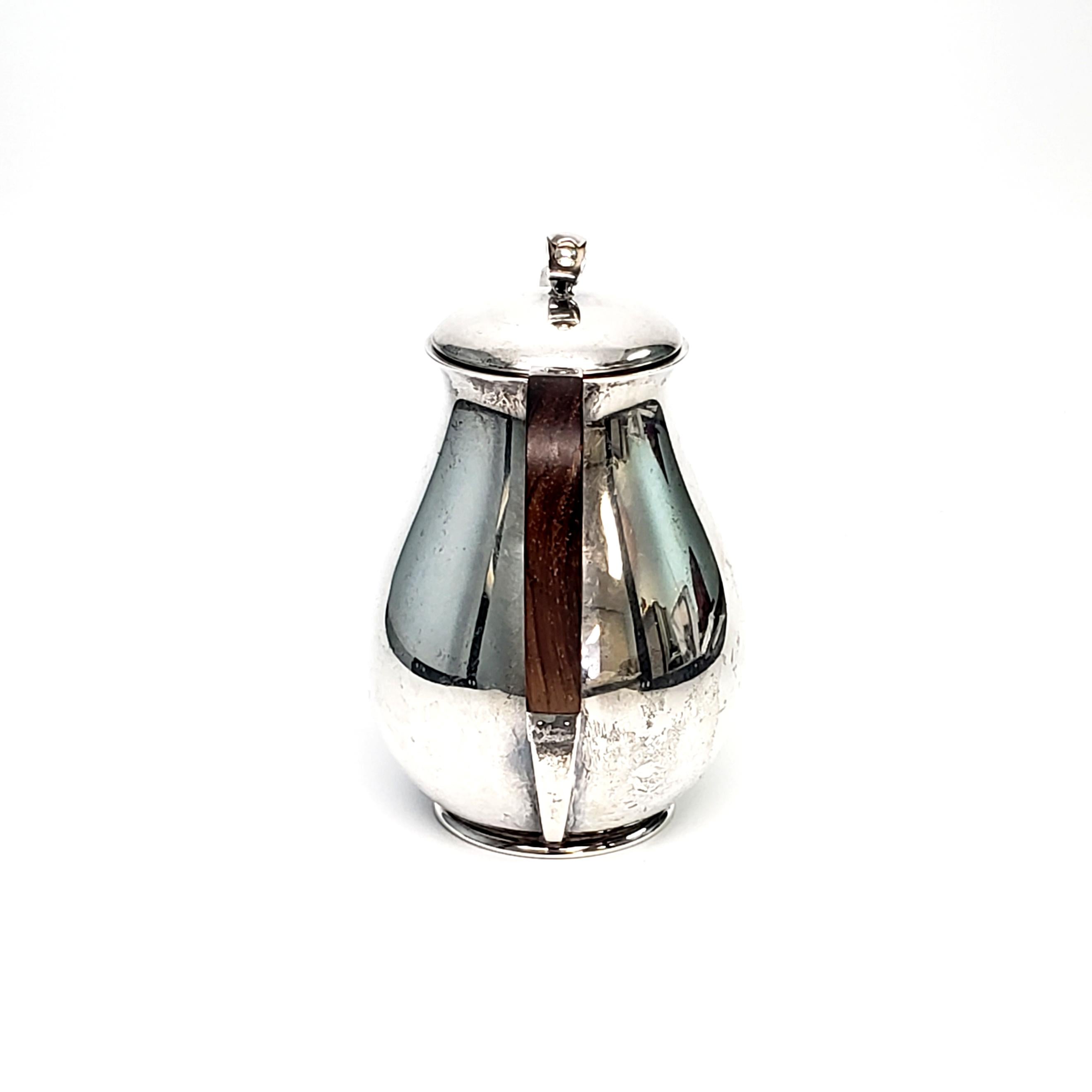Sterling silver coffee pot by Holger Rasmussen of Copenhagen, Denmark 1945-1956.

Simple, clean lined modernist design makes this a timeless piece reminiscent of Georg Jensen's style.

Measures approx 7 1/4