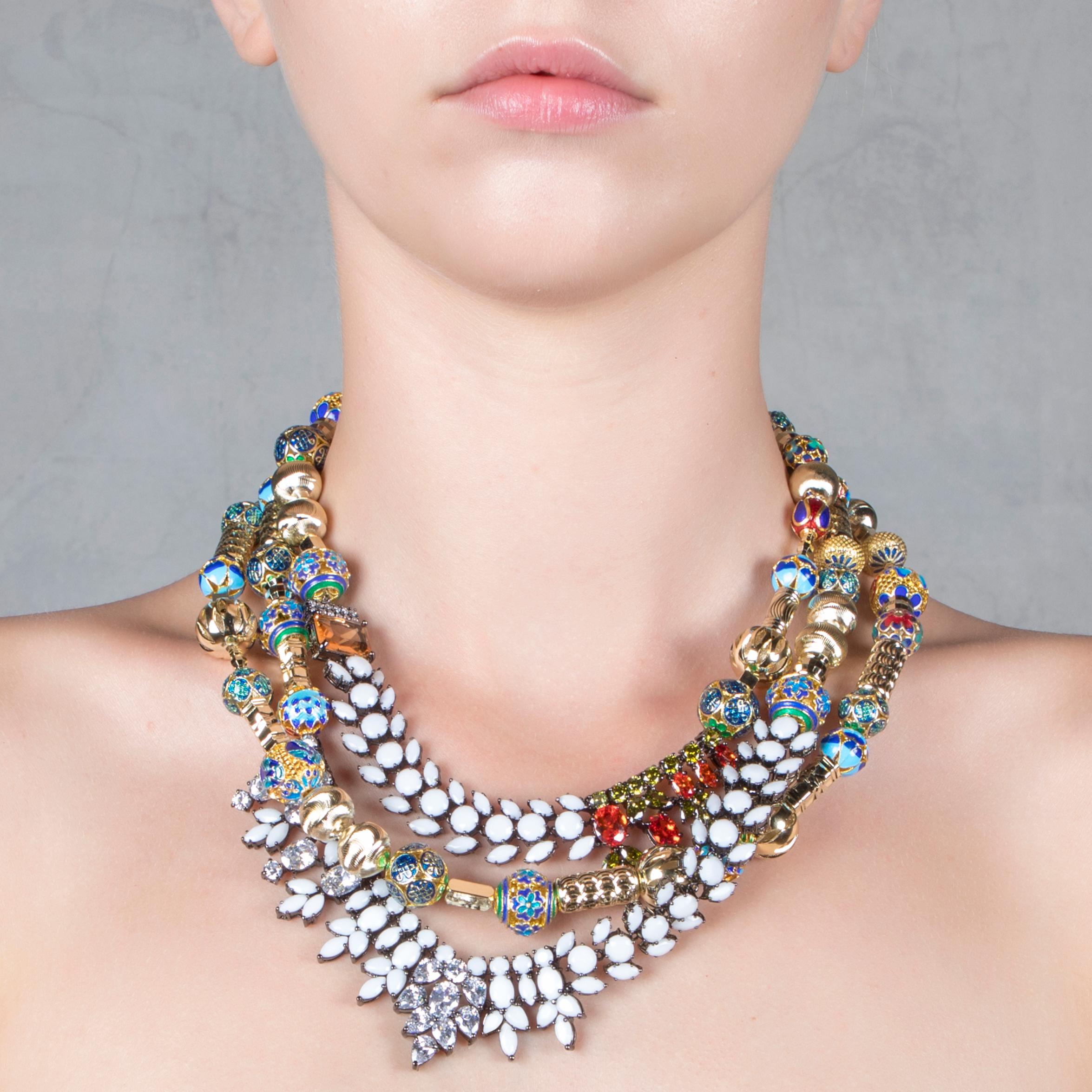 IOSSELLIANI's unique statement necklace is designed to blend some sense of tribal forms into a harmonious balance between elegance and extra impact. The custom made three tiered necklace is dotted with small enamel cloisonnèe beads alternate with 18