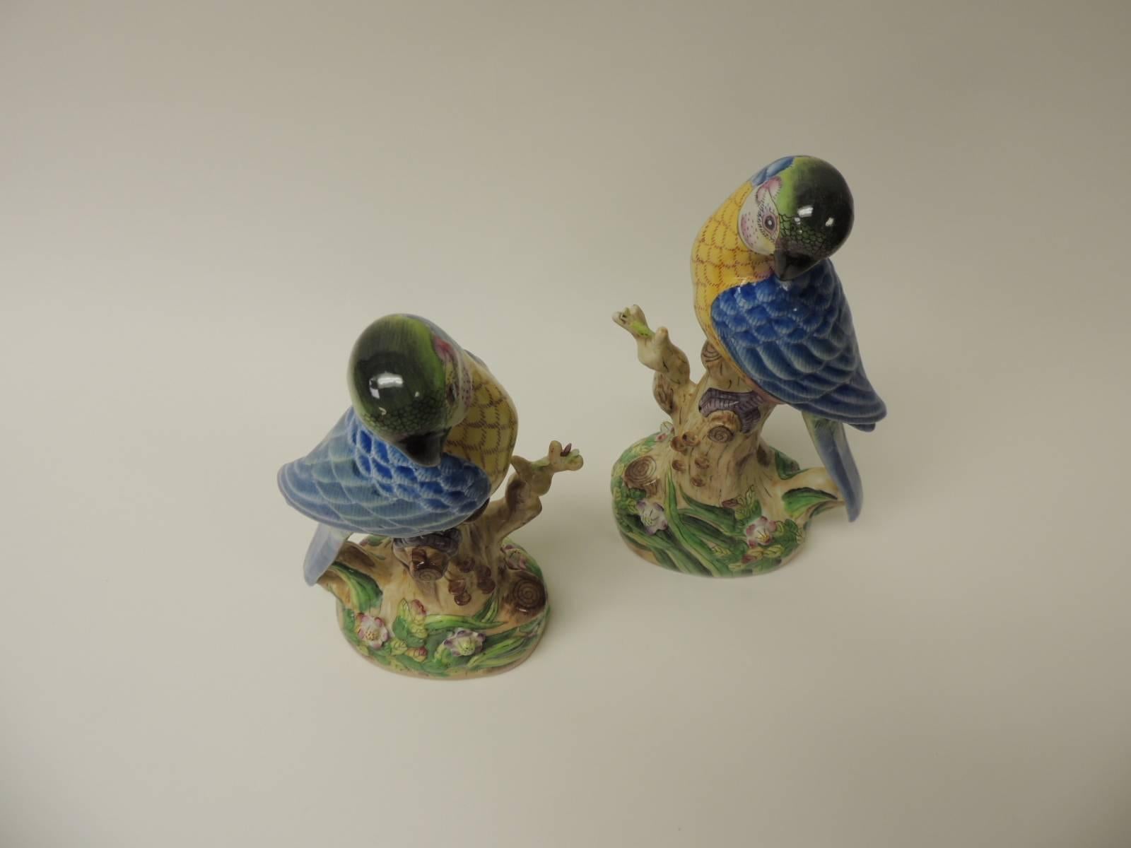Pair of Vintage Chinese Export hand-painted parrots
Pair of intricate hand-painted detailed ceramic Chinese Export parrots. The flowers, the tree trunks and the birds have a real life feel. In shades of yellow, blue, pink, green, purple and black. 