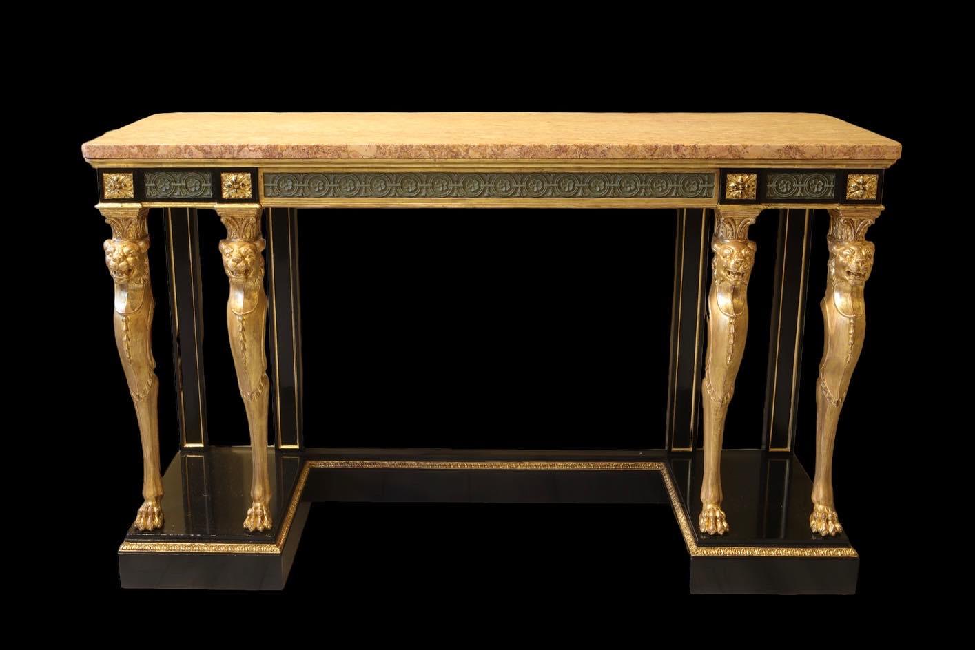 A mahogany and giltwood console table, in the manner of Gottfried Semper, mid 19th century,
with marble top over a frieze drawer stamped ‘Holland & Sons’, supported by four lion monopodia.