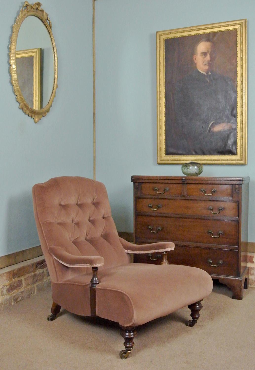 A beautiful 19th century library armchair with a long low seat with tick shape to the side rail and well shaped buttoned back.  The right hand rear leg stamped with the registration number 01329.

This model registration number is for Holland and