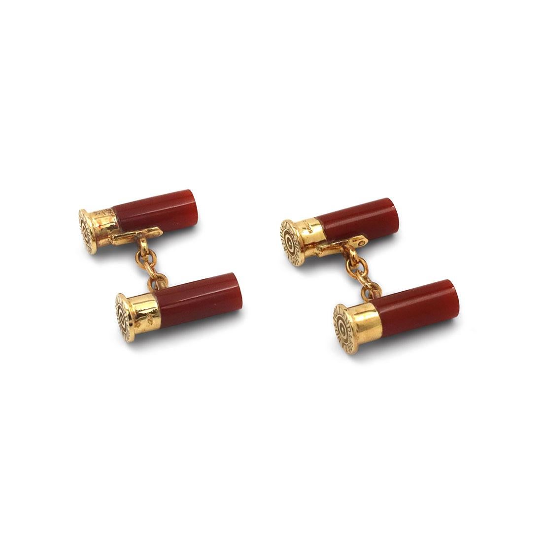 Authentic Holland & Holland cufflinks crafted in 18 karat yellow gold. These unique cufflinks take the design of shotgun bullets. The top portion is crafted in gold and stamped Holland & Holland while the bottom half is set with carnelian. Stamped
