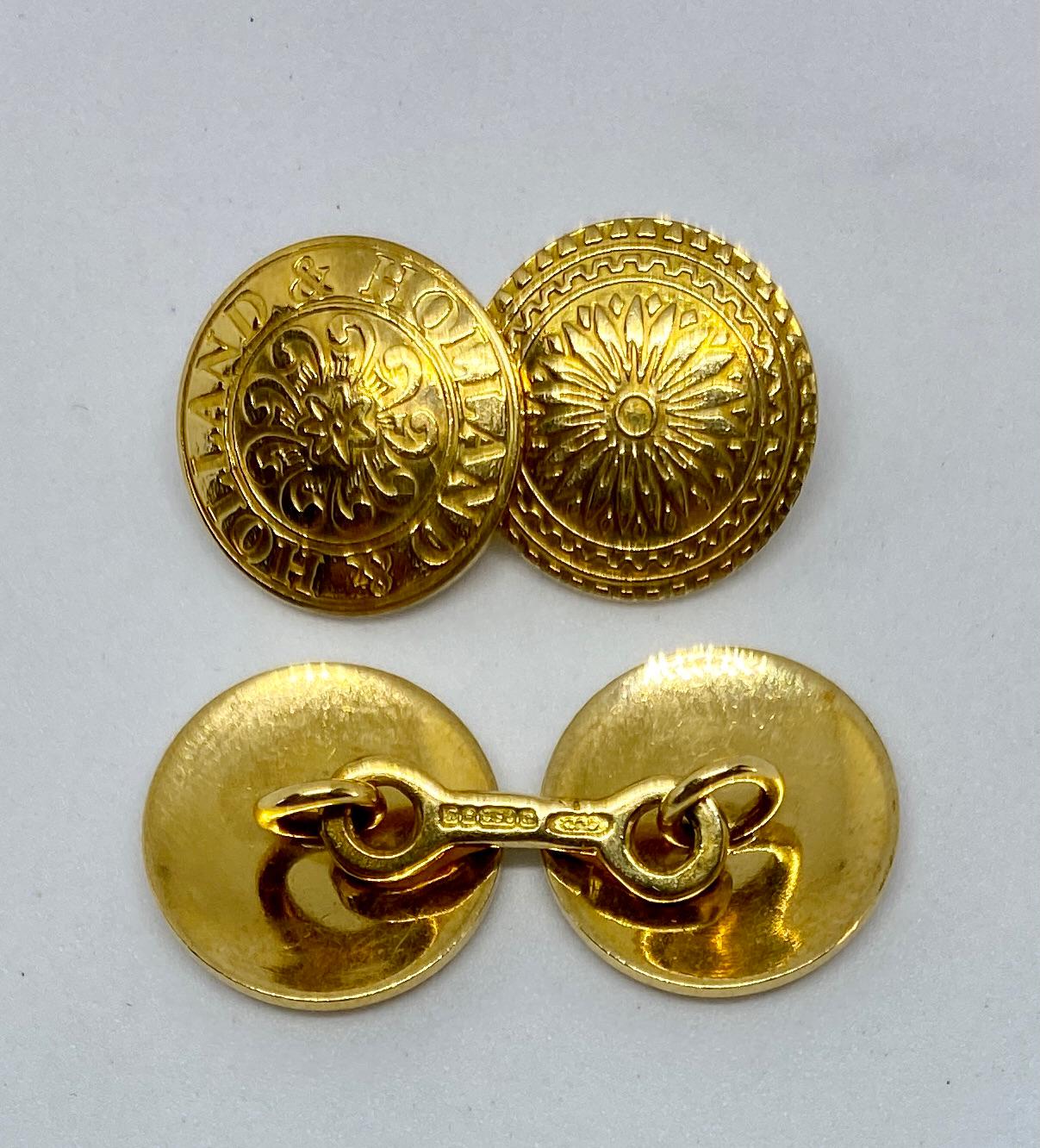 A classic, extremely rare pair of double-sided cufflinks in 18K yellow gold by the esteemed British firm of Holland & Holland. 

Each of the four faces measures 14.1 mm in diameter and features an elaborate yet subtle classical design. One-half of